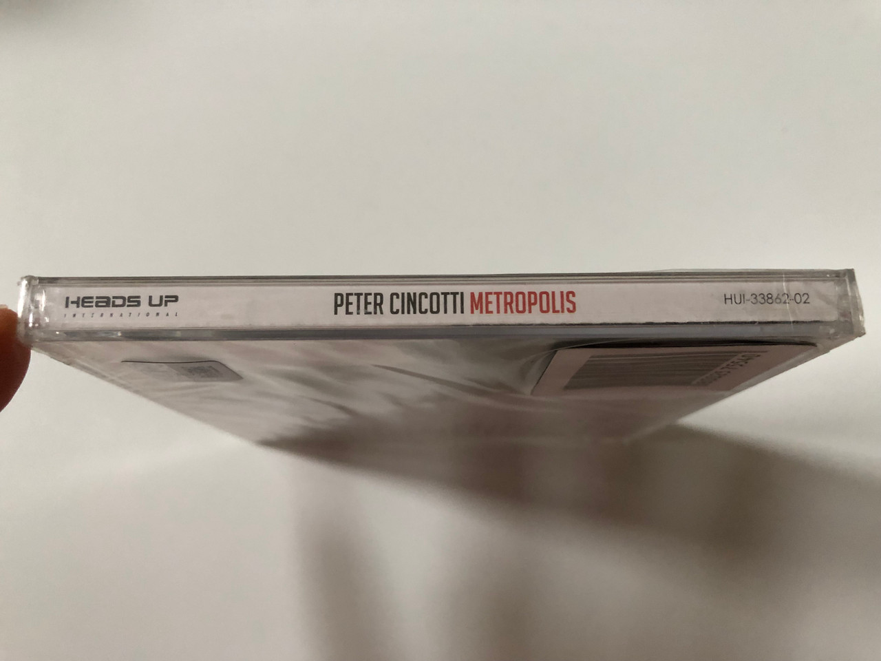 https://cdn10.bigcommerce.com/s-62bdpkt7pb/products/0/images/257759/Peter_Cincotti_Metropolis_Heads_Up_International_Audio_CD_2012_HUI-33862-02_3__19380.1667550798.1280.1280.JPG?c=2&_gl=1*8vrtie*_ga*MjA2NTIxMjE2MC4xNTkwNTEyNTMy*_ga_WS2VZYPC6G*MTY2NzU0NTYyOS42MTcuMS4xNjY3NTUwNjY4LjUxLjAuMA..