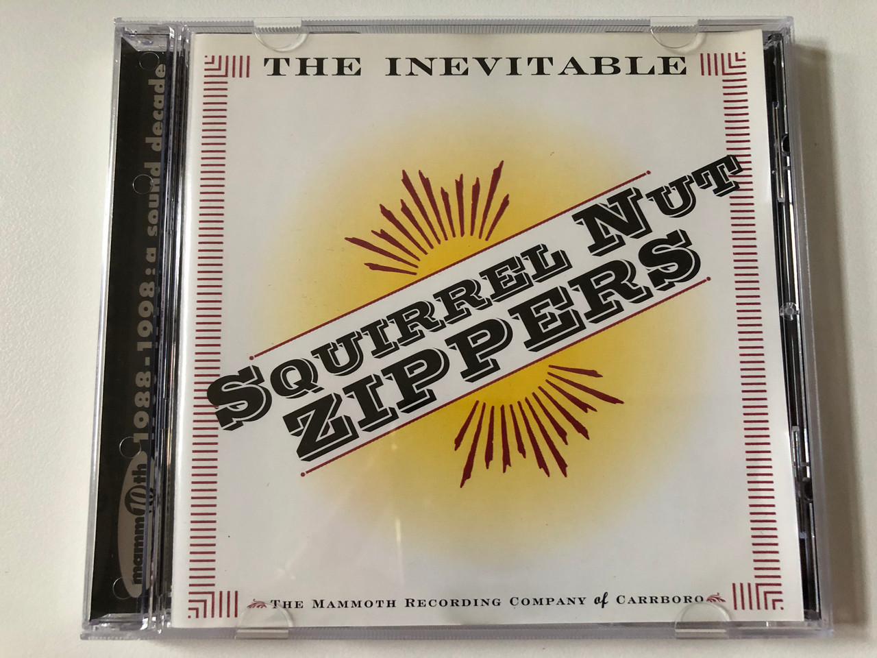 https://cdn10.bigcommerce.com/s-62bdpkt7pb/products/0/images/257955/Squirrel_Nut_Zippers_The_Inevitable_The_Mammoth_Recording_Company_of_Carrboro_Mammoth_Records_Audio_CD_1998_559_257-2_1__62736.1667918491.1280.1280.JPG?c=2&_gl=1*odjif0*_ga*MjA2NTIxMjE2MC4xNTkwNTEyNTMy*_ga_WS2VZYPC6G*MTY2NzkxNzY2My42MjAuMC4xNjY3OTE3NjYzLjYwLjAuMA..