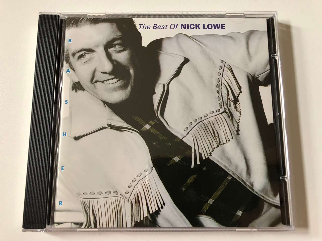 https://cdn10.bigcommerce.com/s-62bdpkt7pb/products/0/images/258015/Basher_The_Best_Of_Nick_Lowe_Demon_Records_Audio_CD_1989_FIEND_CD_142_1__06519.1667934036.1280.1280.JPG?c=2&_gl=1*1lpzihd*_ga*MjA2NTIxMjE2MC4xNTkwNTEyNTMy*_ga_WS2VZYPC6G*MTY2NzkzMzM1OS42MjEuMS4xNjY3OTMzOTYwLjUzLjAuMA..