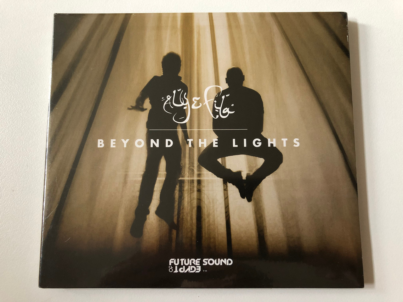 https://cdn10.bigcommerce.com/s-62bdpkt7pb/products/0/images/258068/Aly_Fila_Beyond_The_Lights_FSOE_Recordings_Audio_CD_2017_FSOECD003_1__13166.1668013896.1280.1280.JPG?c=2&_gl=1*1lfkg7n*_ga*MjA2NTIxMjE2MC4xNTkwNTEyNTMy*_ga_WS2VZYPC6G*MTY2ODAwNTc2MC42MjIuMS4xNjY4MDEzNzAzLjQ4LjAuMA..