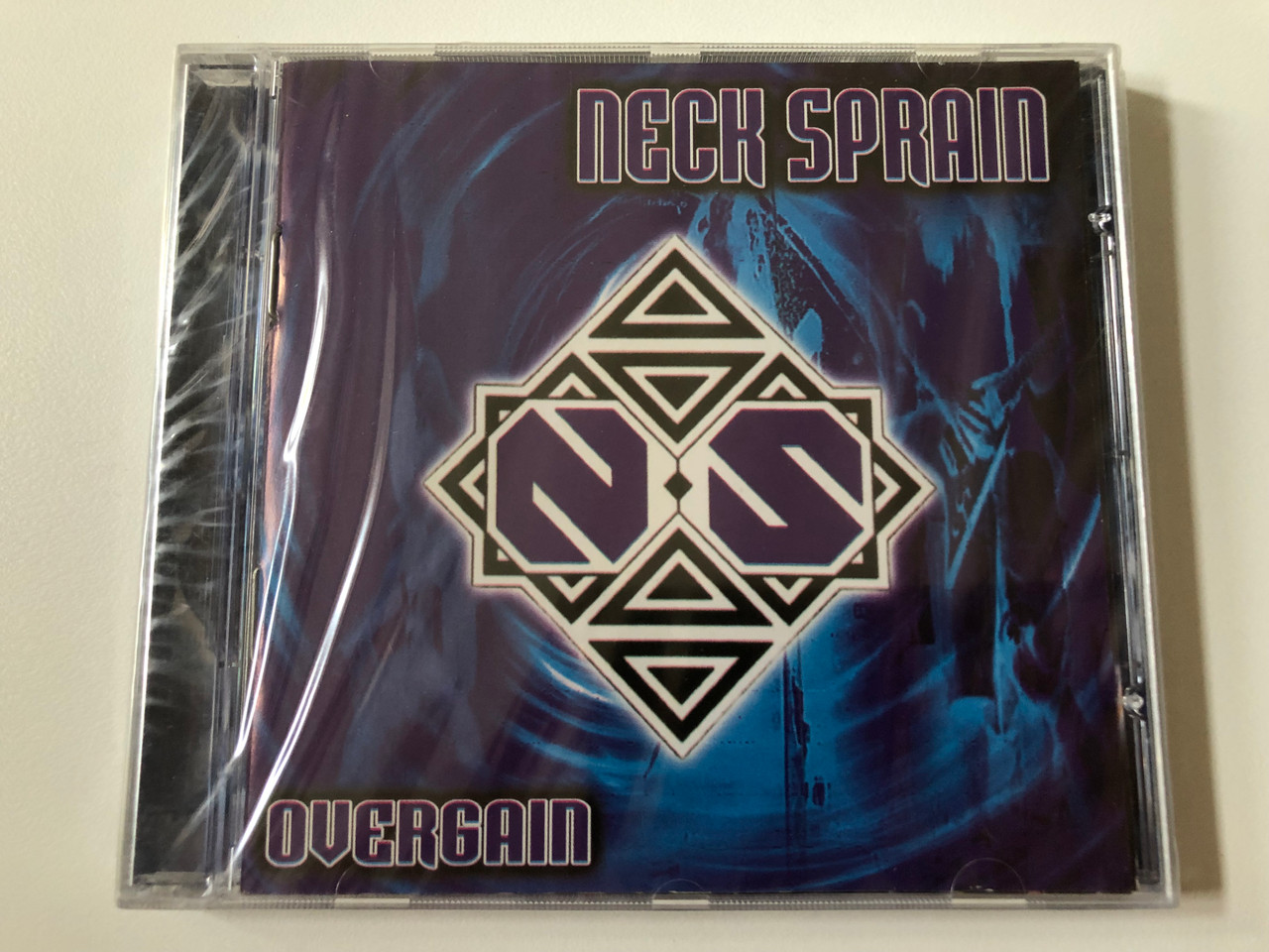 https://cdn10.bigcommerce.com/s-62bdpkt7pb/products/0/images/258129/Neck_Sprain_Overgain_Hammer_Music_Productions_Audio_CD_1999_HMPCD_004_1__94270.1668091738.1280.1280.JPG?c=2&_gl=1*q569yt*_ga*MjA2NTIxMjE2MC4xNTkwNTEyNTMy*_ga_WS2VZYPC6G*MTY2ODA5MDgxOC42MjQuMS4xNjY4MDkxMTAwLjExLjAuMA..
