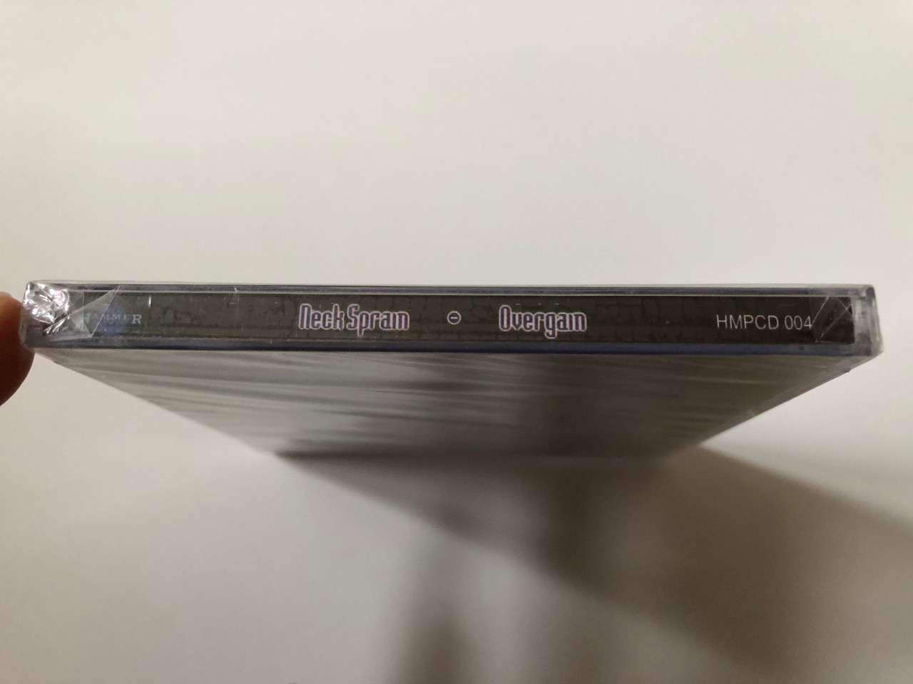 https://cdn10.bigcommerce.com/s-62bdpkt7pb/products/0/images/258131/Neck_Sprain_Overgain_Hammer_Music_Productions_Audio_CD_1999_HMPCD_004_3__95896.1668091754.1280.1280.JPG?c=2&_gl=1*q569yt*_ga*MjA2NTIxMjE2MC4xNTkwNTEyNTMy*_ga_WS2VZYPC6G*MTY2ODA5MDgxOC42MjQuMS4xNjY4MDkxMTAwLjExLjAuMA..