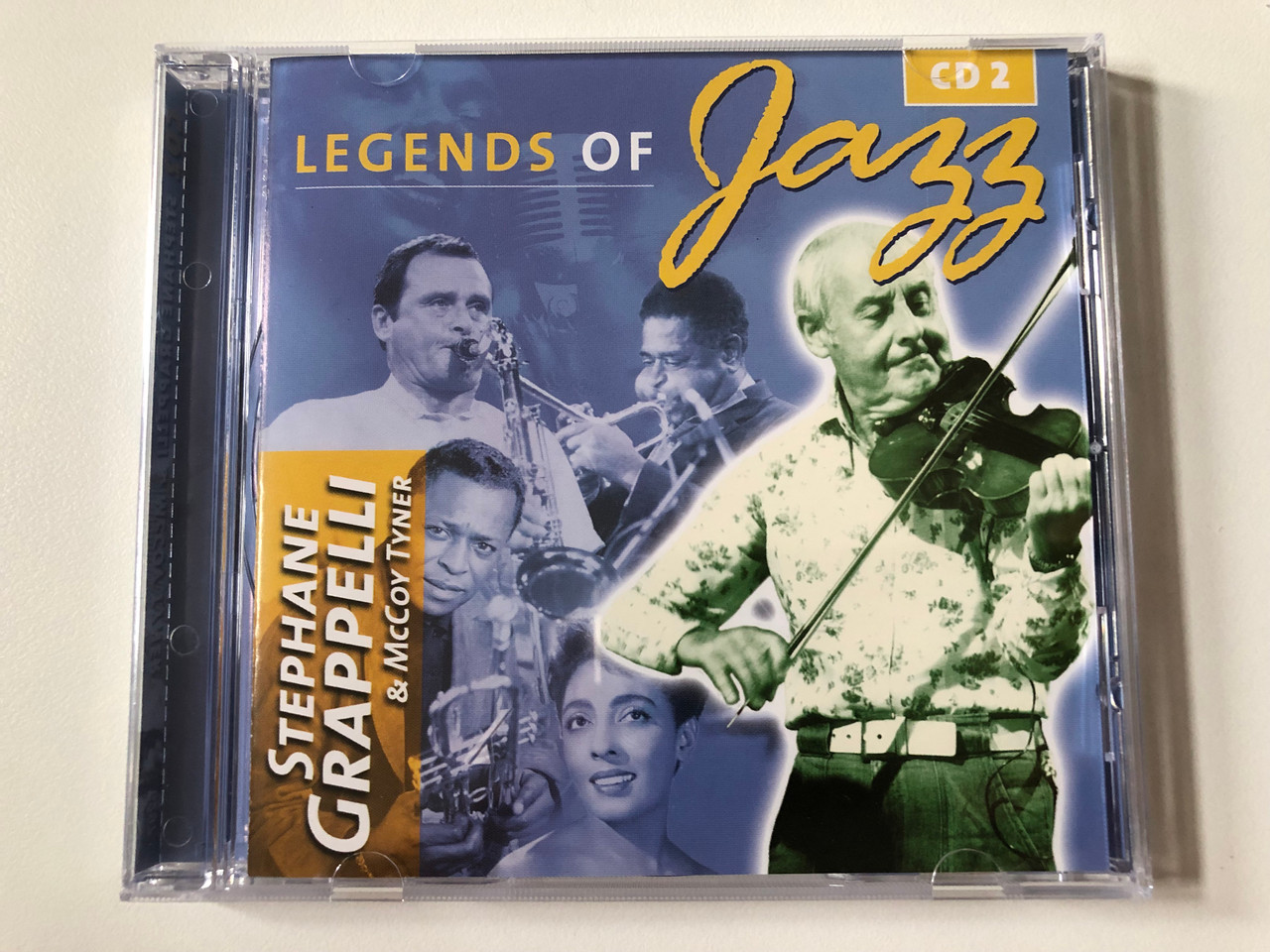 https://cdn10.bigcommerce.com/s-62bdpkt7pb/products/0/images/258529/Legends_Of_Jazz_-_CD_2_-_Stephane_Grappeli_McCoy_Tyner_Rainbowcd.com_Audio_CD_6297_1__31622.1668189910.1280.1280.JPG?c=2&_gl=1*1hhs7nd*_ga*MjA2NTIxMjE2MC4xNTkwNTEyNTMy*_ga_WS2VZYPC6G*MTY2ODE4NDg1Mi42MjYuMS4xNjY4MTg5OTUwLjYwLjAuMA..