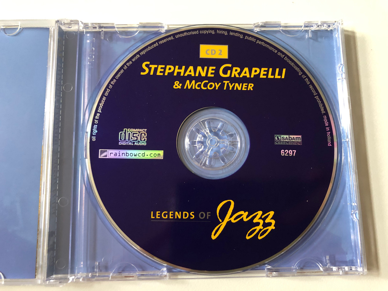 https://cdn10.bigcommerce.com/s-62bdpkt7pb/products/0/images/258531/Legends_Of_Jazz_-_CD_2_-_Stephane_Grappeli_McCoy_Tyner_Rainbowcd.com_Audio_CD_6297_3__55908.1668189939.1280.1280.JPG?c=2&_gl=1*1hhs7nd*_ga*MjA2NTIxMjE2MC4xNTkwNTEyNTMy*_ga_WS2VZYPC6G*MTY2ODE4NDg1Mi42MjYuMS4xNjY4MTg5OTUwLjYwLjAuMA..