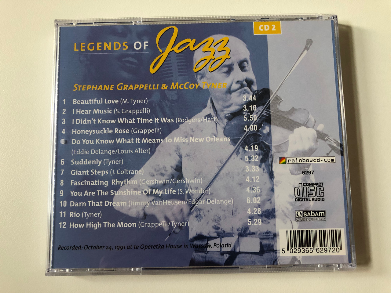 https://cdn10.bigcommerce.com/s-62bdpkt7pb/products/0/images/258532/Legends_Of_Jazz_-_CD_2_-_Stephane_Grappeli_McCoy_Tyner_Rainbowcd.com_Audio_CD_6297_4__44900.1668189949.1280.1280.JPG?c=2&_gl=1*1hhs7nd*_ga*MjA2NTIxMjE2MC4xNTkwNTEyNTMy*_ga_WS2VZYPC6G*MTY2ODE4NDg1Mi42MjYuMS4xNjY4MTg5OTUwLjYwLjAuMA..