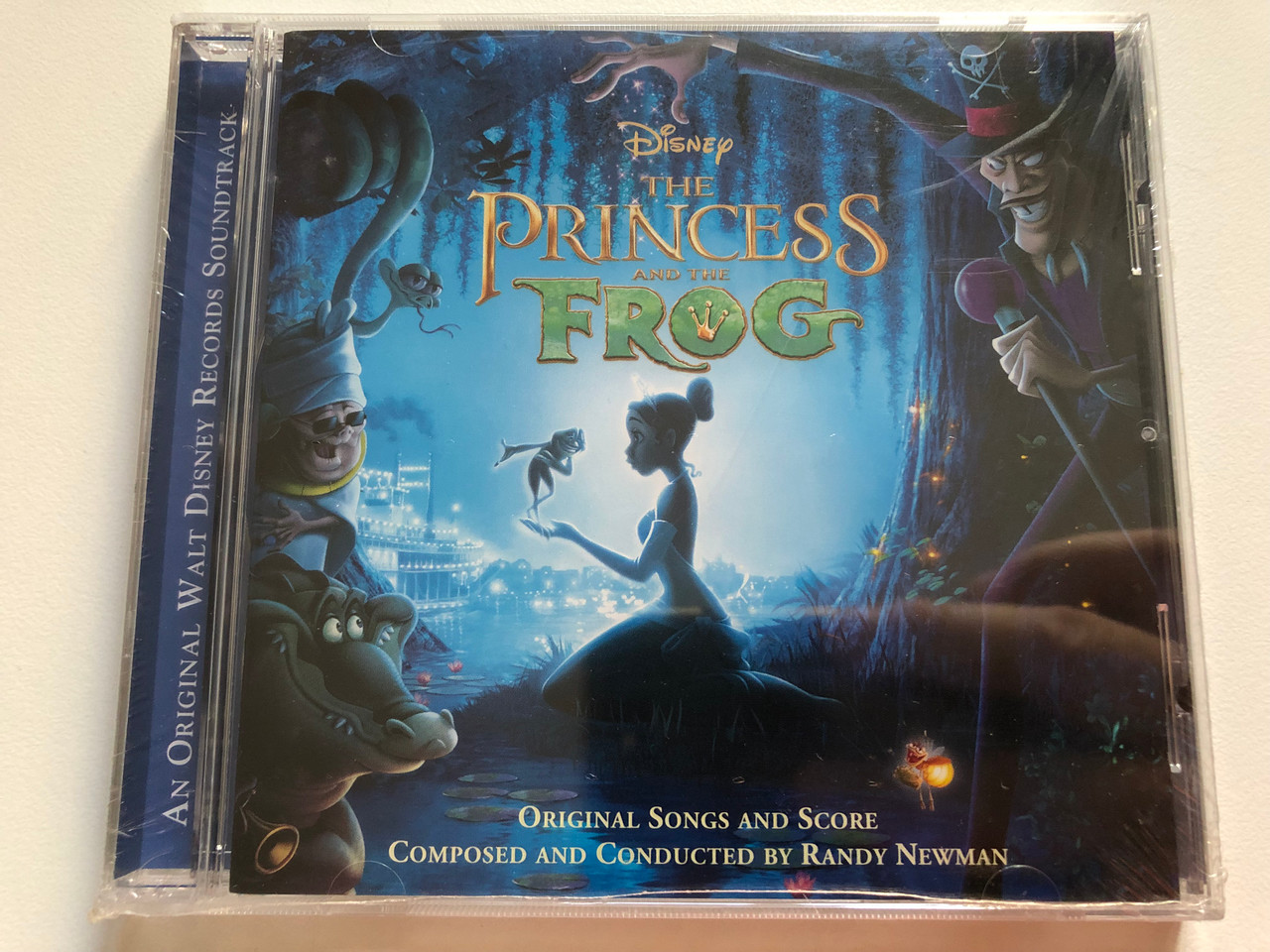 https://cdn10.bigcommerce.com/s-62bdpkt7pb/products/0/images/259423/The_Princess_And_The_Frog_-_Composed_And_Conducted_By_Randy_Newman_Original_Songs_And_Score_Walt_Disney_Records_Audio_CD_2009_5099945674921_1__83112.1669294169.1280.1280.JPG?c=2&_gl=1*snv17t*_ga*MjA2NTIxMjE2MC4xNTkwNTEyNTMy*_ga_WS2VZYPC6G*MTY2OTI5MDM4MC42NDIuMS4xNjY5Mjk0MTQxLjYwLjAuMA..