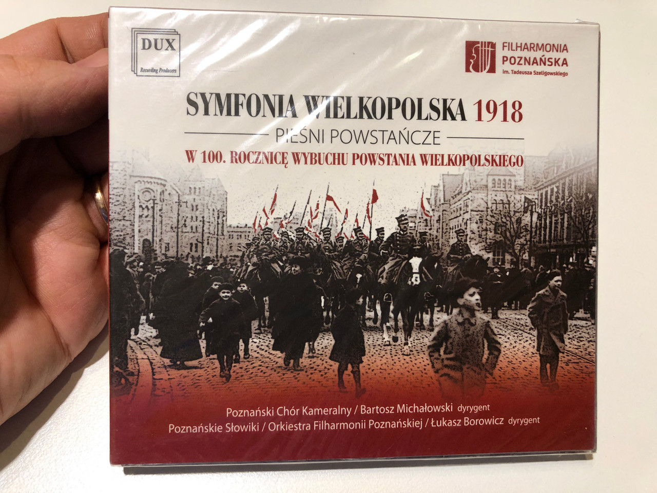 https://cdn10.bigcommerce.com/s-62bdpkt7pb/products/0/images/259714/Symfonia_Wielkopolska_1918_-_Piesni_Powstancze_-_W_100._Rocznice_Wybuchu_Powstania_Wielkopolskiego_Poznanski_Chor_Kameralny_Bartosz_Michalowski_dyrygent_DUX_Recording_Producers_Audio_CD_1__17802.1669722042.1280.1280.JPG?c=2&_gl=1*ad3rum*_ga*MjA2NTIxMjE2MC4xNTkwNTEyNTMy*_ga_WS2VZYPC6G*MTY2OTcxNTUzMi42NTAuMS4xNjY5NzIxODQ3LjQxLjAuMA..