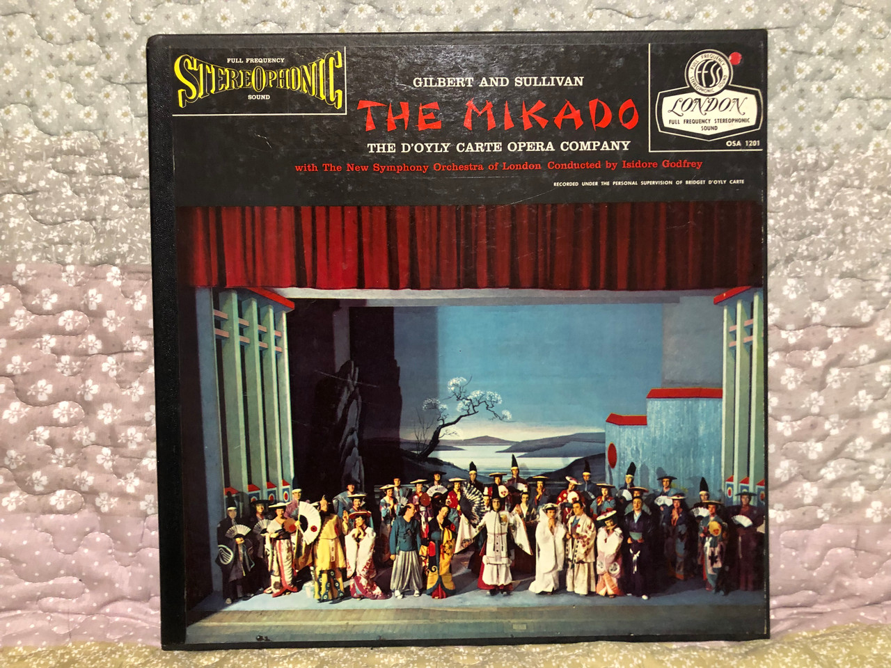 https://cdn10.bigcommerce.com/s-62bdpkt7pb/products/0/images/260237/Gilbert_And_Sullivan_-_The_Mikado_-_DOyly_Carte_Opera_Company_with_The_New_Symphony_Orchestra_Of_London_Conducted_By_Isidore_Godfrey_London_Records_2x_LP_OSA-1201_1__64506.1670520805.1280.1280.JPG?c=2&_gl=1*1x4x9f6*_ga*MjA2NTIxMjE2MC4xNTkwNTEyNTMy*_ga_WS2VZYPC6G*MTY3MDUxMTg2My42NjEuMS4xNjcwNTIwNzYwLjYwLjAuMA..