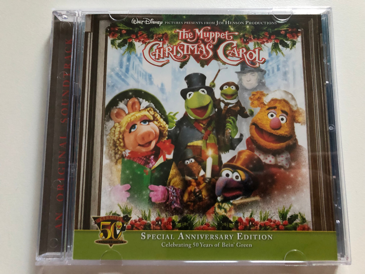 https://cdn10.bigcommerce.com/s-62bdpkt7pb/products/0/images/261736/The_Muppet_Christmas_Carol_-_Special_Anniversary_Edition_Celebrating_50_Years_of_Bein_Green_Walt_Disney_Pictures_Presents_From_Jim_Henson_Productions_Walt_Disney_Records_Audio_CD_2006_0_1__64653.1671703708.1280.1280.JPG?c=2&_gl=1*29xbes*_ga*MjA2NTIxMjE2MC4xNTkwNTEyNTMy*_ga_WS2VZYPC6G*MTY3MTY5NjU5Ny42ODIuMS4xNjcxNzAzNjc1LjYwLjAuMA..