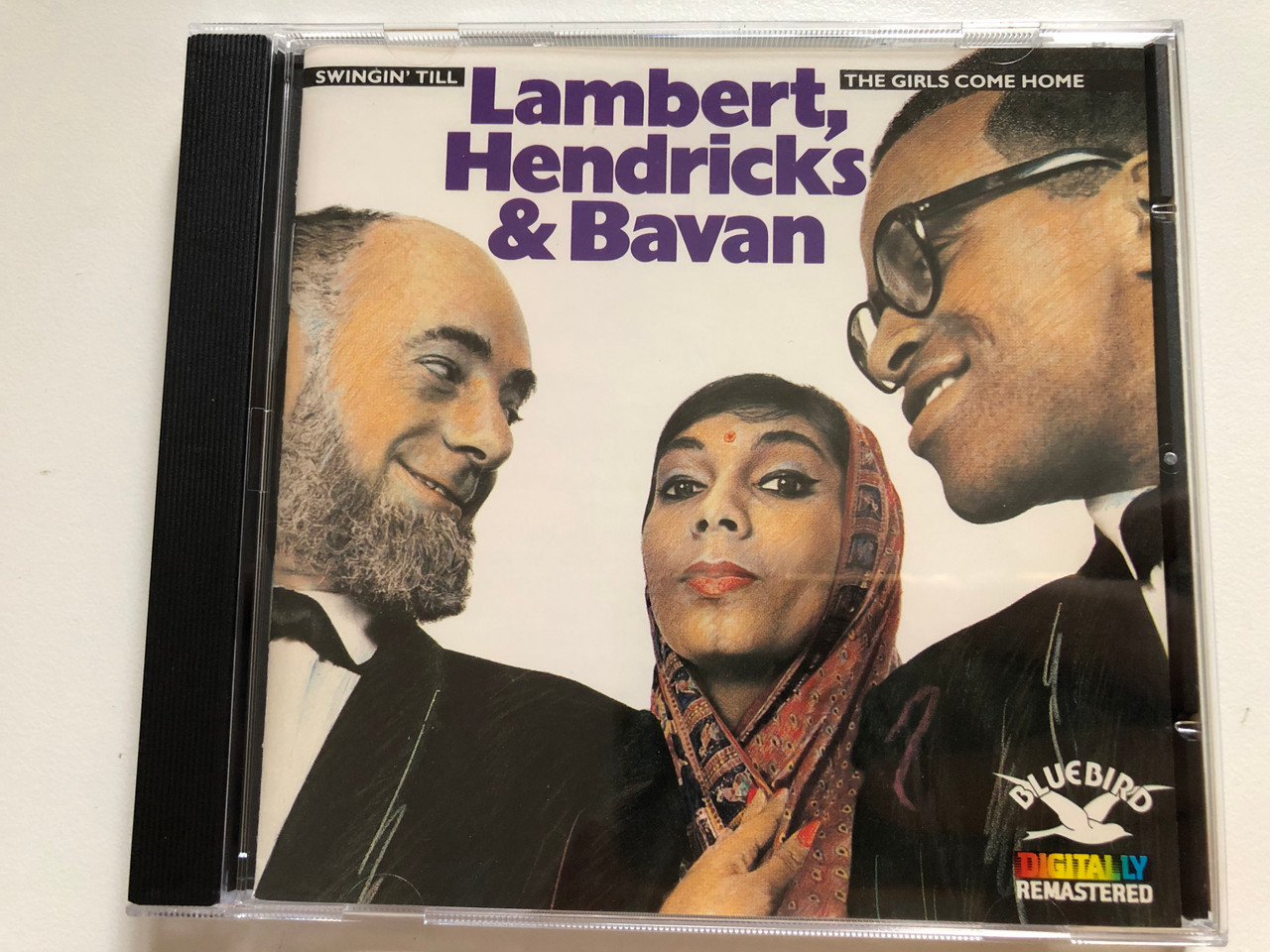 https://cdn10.bigcommerce.com/s-62bdpkt7pb/products/0/images/261974/Lambert_Hendricks_Bavan_Swingin_Till_The_Girls_Come_Home_Bluebird_Audio_CD_1987_6282-2-RBLambert_Hendricks_Bavan_Swingin_Till_The_Girls_Come_Home_Bluebird_Audio_CD_1987_6282-2_1__46077.1671793228.1280.1280.JPG?c=2&_gl=1*dy8mh*_ga*MjA2NTIxMjE2MC4xNTkwNTEyNTMy*_ga_WS2VZYPC6G*MTY3MTc4MTY4Mi42ODUuMS4xNjcxNzkzMTI4LjM2LjAuMA..