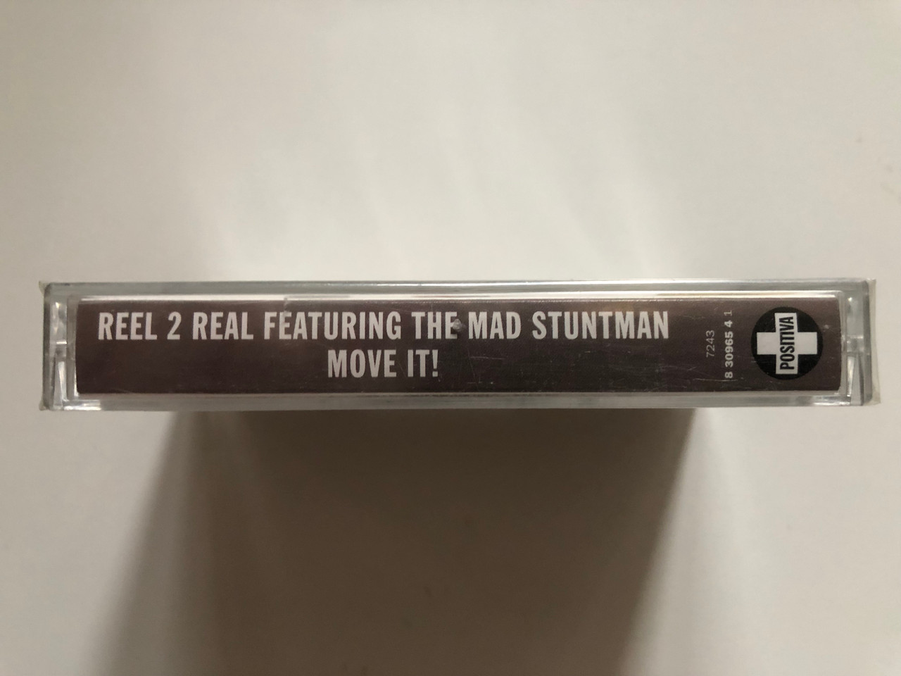 https://cdn10.bigcommerce.com/s-62bdpkt7pb/products/0/images/262838/Reel_2_Real_The_Mad_Stuntman_Move_It_Includes_The_Hit_Singles_I_Like_To_Move_It_Go_On_Move_Can_You_Feel_It_Positiva_Audio_Cassette_1994_724383096541_3__90450.1672650766.1280.1280.JPG?c=2&_gl=1*19uk8xo*_ga*MjA2NTIxMjE2MC4xNTkwNTEyNTMy*_ga_WS2VZYPC6G*MTY3MjY0MTAyNS42OTQuMS4xNjcyNjUwNTA0LjQ4LjAuMA..