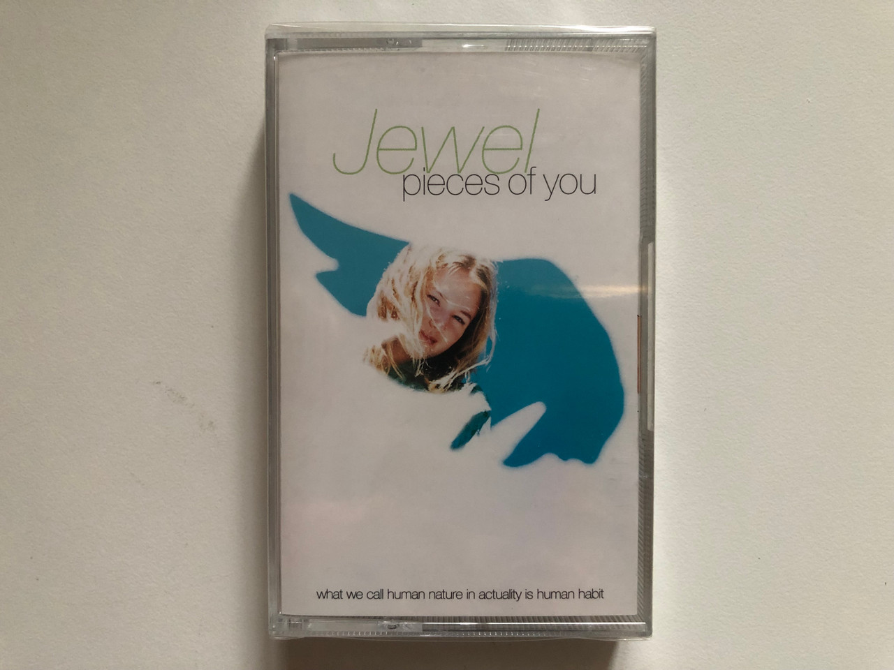 https://cdn10.bigcommerce.com/s-62bdpkt7pb/products/0/images/262848/Jewel_Pieces_Of_You_What_We_Call_Human_Nature_In_Actuality_Is_Human_Habit_Atlantic_Audio_Cassette_1994_7567-82700-4_1__10498.1672653565.1280.1280.JPG?c=2&_gl=1*1cculqm*_ga*MjA2NTIxMjE2MC4xNTkwNTEyNTMy*_ga_WS2VZYPC6G*MTY3MjY0MTAyNS42OTQuMS4xNjcyNjUzMjM3LjYwLjAuMA..