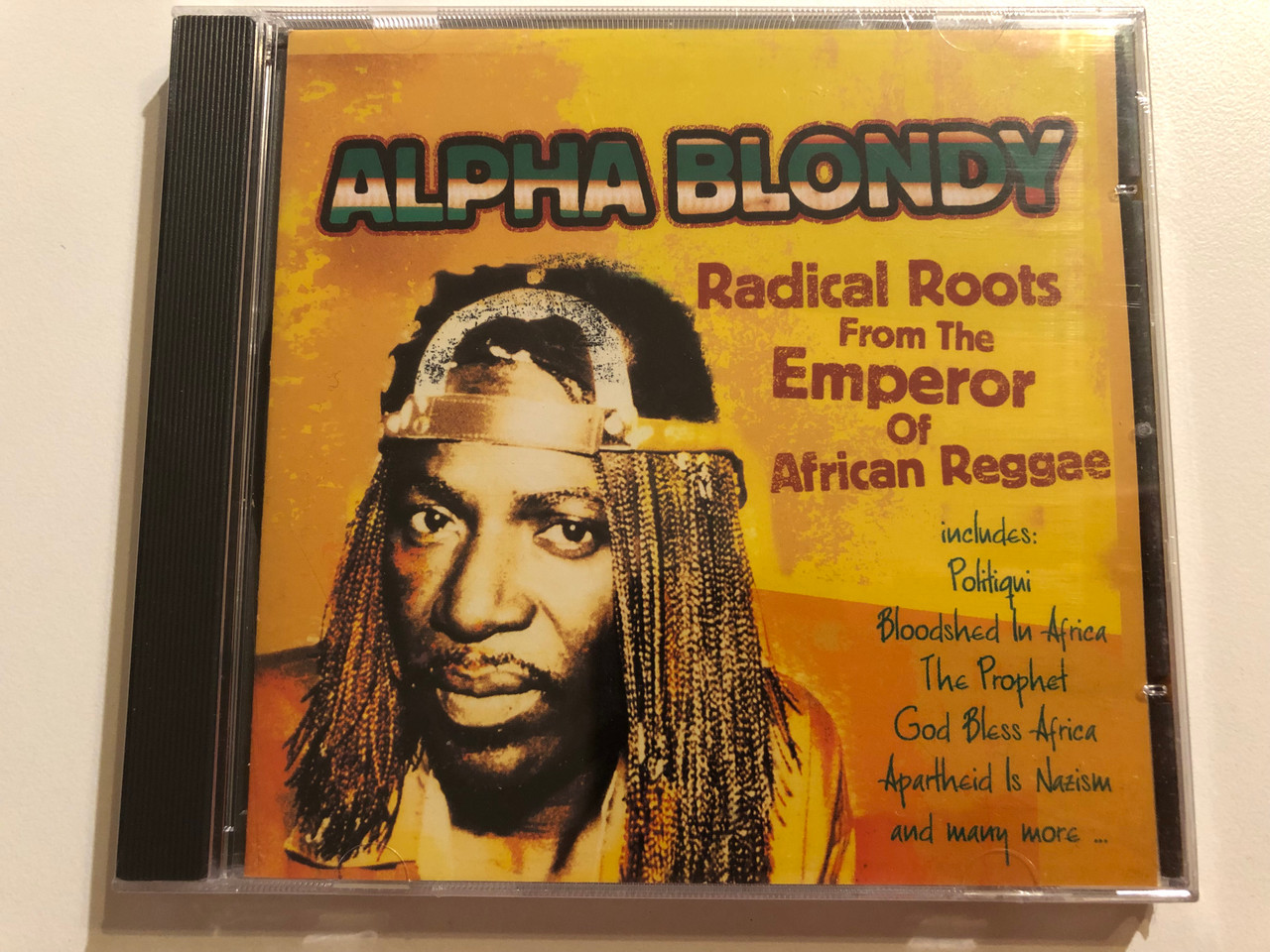 https://cdn10.bigcommerce.com/s-62bdpkt7pb/products/0/images/264392/Alpha_Blondy_Radical_Roots_From_The_Emperor_Of_African_Reggae_-_Includes_Politiqui_Bloodshed_In_Africa_The_Prophet_God_Bless_Africa_Apartheid_Is_Nazism_and_many_more..._Manteca_Audio_CD_1__92487.1674143208.1280.1280.JPG?c=2&_gl=1*1cimm5h*_ga*MjA2NTIxMjE2MC4xNTkwNTEyNTMy*_ga_WS2VZYPC6G*MTY3NDE0MTQxMy43MjEuMS4xNjc0MTQzMTkyLjYwLjAuMA..
