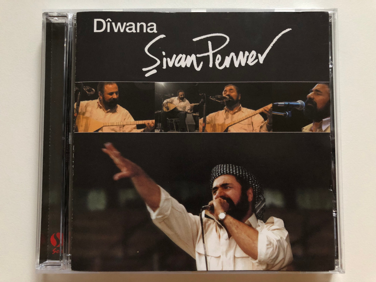 https://cdn10.bigcommerce.com/s-62bdpkt7pb/products/0/images/264839/Sivan_Perwer_-_Diwana_Ses_Plak_Yapim_Audio_CD_2005_156_1__07552.1674710295.1280.1280.JPG?c=2&_gl=1*1ww8gk6*_ga*MjA2NTIxMjE2MC4xNTkwNTEyNTMy*_ga_WS2VZYPC6G*MTY3NDcwNzU2MS43MzEuMS4xNjc0NzEwNDExLjYwLjAuMA..