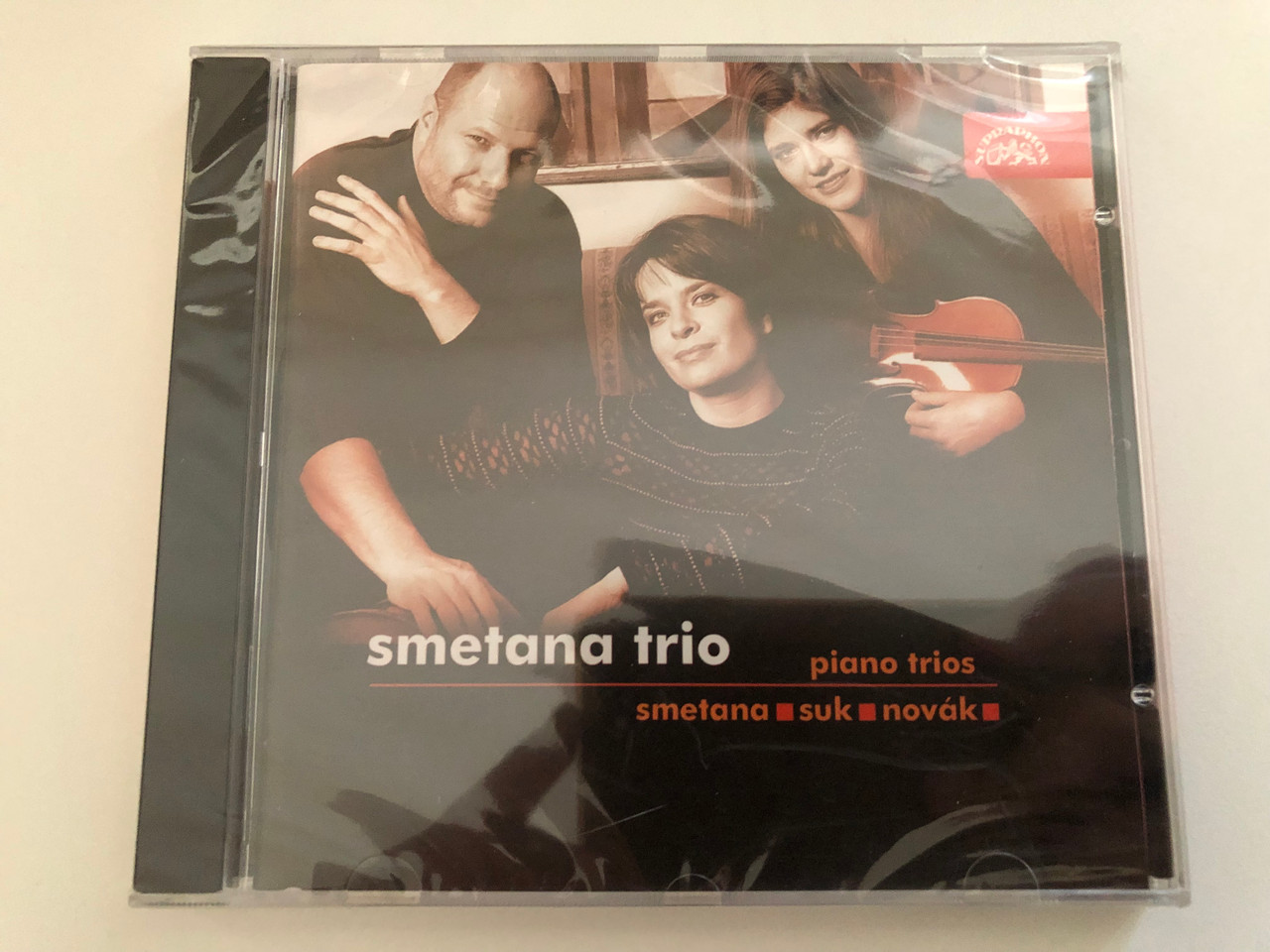 https://cdn10.bigcommerce.com/s-62bdpkt7pb/products/0/images/269313/Smetana_Trio_Piano_Trios_Smetana_Suk_Novk_Supraphon_Audio_CD_2005_SU_3810-2_1__16916.1678434544.1280.1280.JPG?c=2&_gl=1*1uhv1m1*_ga*MjA2NTIxMjE2MC4xNTkwNTEyNTMy*_ga_WS2VZYPC6G*MTY3ODQyOTUzMy44MDAuMS4xNjc4NDM0Mjc1LjU4LjAuMA..