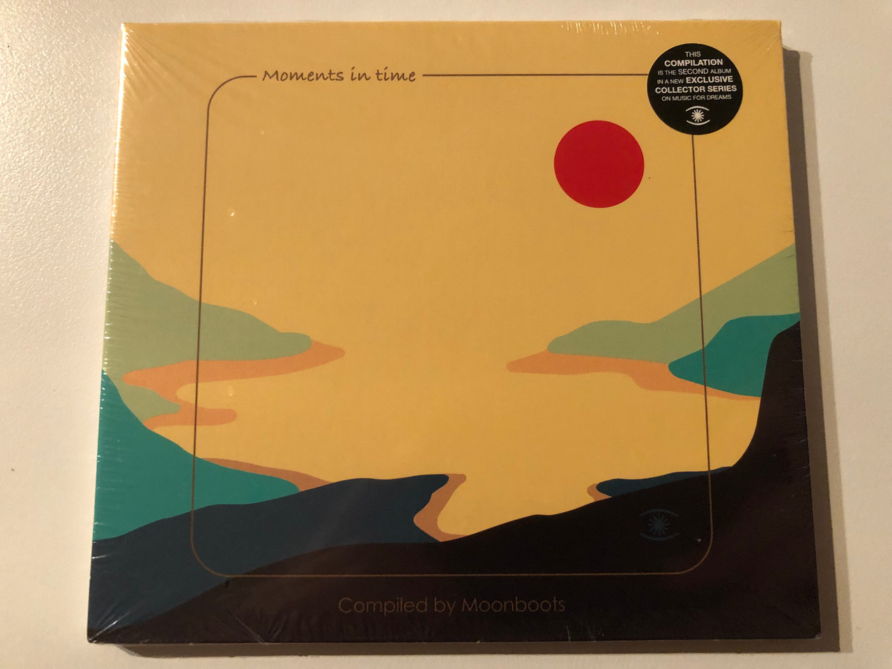 https://cdn10.bigcommerce.com/s-62bdpkt7pb/products/0/images/269619/Moments_In_Time_-_Complied_By_Moonboots_This_Compilation_Is_The_Second_Album_In_A_New_Exclusive_Collector_Series_On_Music_For_Dreams_Music_For_Dreams_Audio_CD_ZZZCD0121_1__32563.1678908012.1280.1280.JPG?c=2&_gl=1*69c4qa*_ga*MjA2NTIxMjE2MC4xNTkwNTEyNTMy*_ga_WS2VZYPC6G*MTY3ODkwMDQ1NC44MDYuMS4xNjc4OTA3ODU2LjQ0LjAuMA..