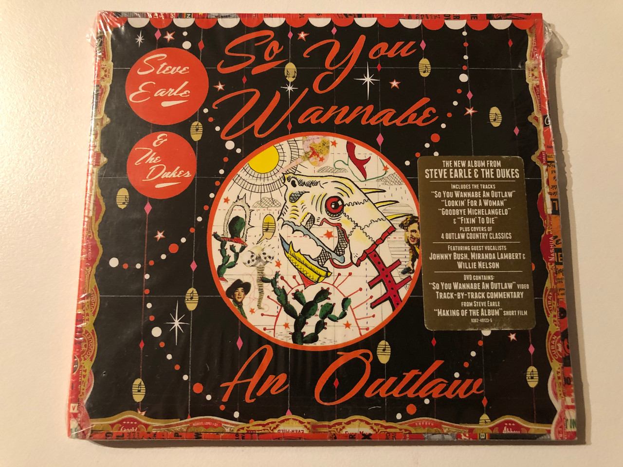 https://cdn10.bigcommerce.com/s-62bdpkt7pb/products/0/images/270341/Steve_Earle_The_Dukes_So_You_Wannabe_An_Outlaw_The_New_Album_From_Steve_Earle_The_Dukes_Includes_The_Tracks_So_You_Wannabe_An_Outlaw_Lookin_For_A_Woman_Warner_Bros._Record_1__92997.1679568386.1280.1280.JPG?c=2&_gl=1*ukovfd*_ga*MjA2NTIxMjE2MC4xNTkwNTEyNTMy*_ga_WS2VZYPC6G*MTY3OTU2NDYxNy44MTkuMS4xNjc5NTY4MDc5LjM4LjAuMA..