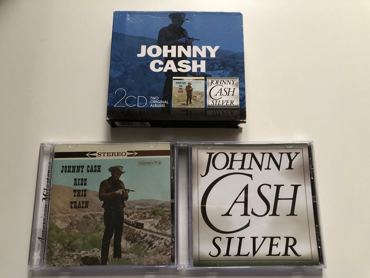 https://cdn10.bigcommerce.com/s-62bdpkt7pb/products/0/images/272287/Johnny_Cash_-_Ride_This_Train_Silver_Sony_Music_2x_Audio_CD_2013_88883737612_5__59918.1681142304.1280.1280.JPG?c=2&_gl=1*x8zrxq*_ga*MjA2NTIxMjE2MC4xNTkwNTEyNTMy*_ga_WS2VZYPC6G*MTY4MTEzMTk2MC44NDIuMS4xNjgxMTQyMzU3LjYwLjAuMA..