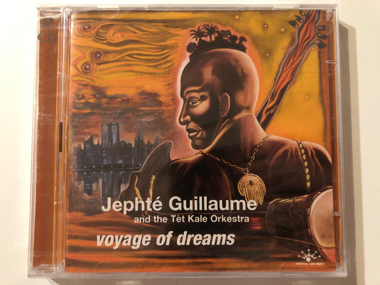 https://cdn10.bigcommerce.com/s-62bdpkt7pb/products/0/images/275740/Jepht_Guillaume_And_The_Tt_Kale_Orkestra_Voyage_Of_Dreams_Spiritual_Life_Music_2x_Audio_CD_2002_SLMCD-363_1__37625.1685515767.1280.1280.JPG?c=2&_gl=1*1pdqq1l*_ga*MjA2NTIxMjE2MC4xNTkwNTEyNTMy*_ga_WS2VZYPC6G*MTY4NTUxMjMwNC45MjAuMS4xNjg1NTE1NTAwLjQ0LjAuMA..