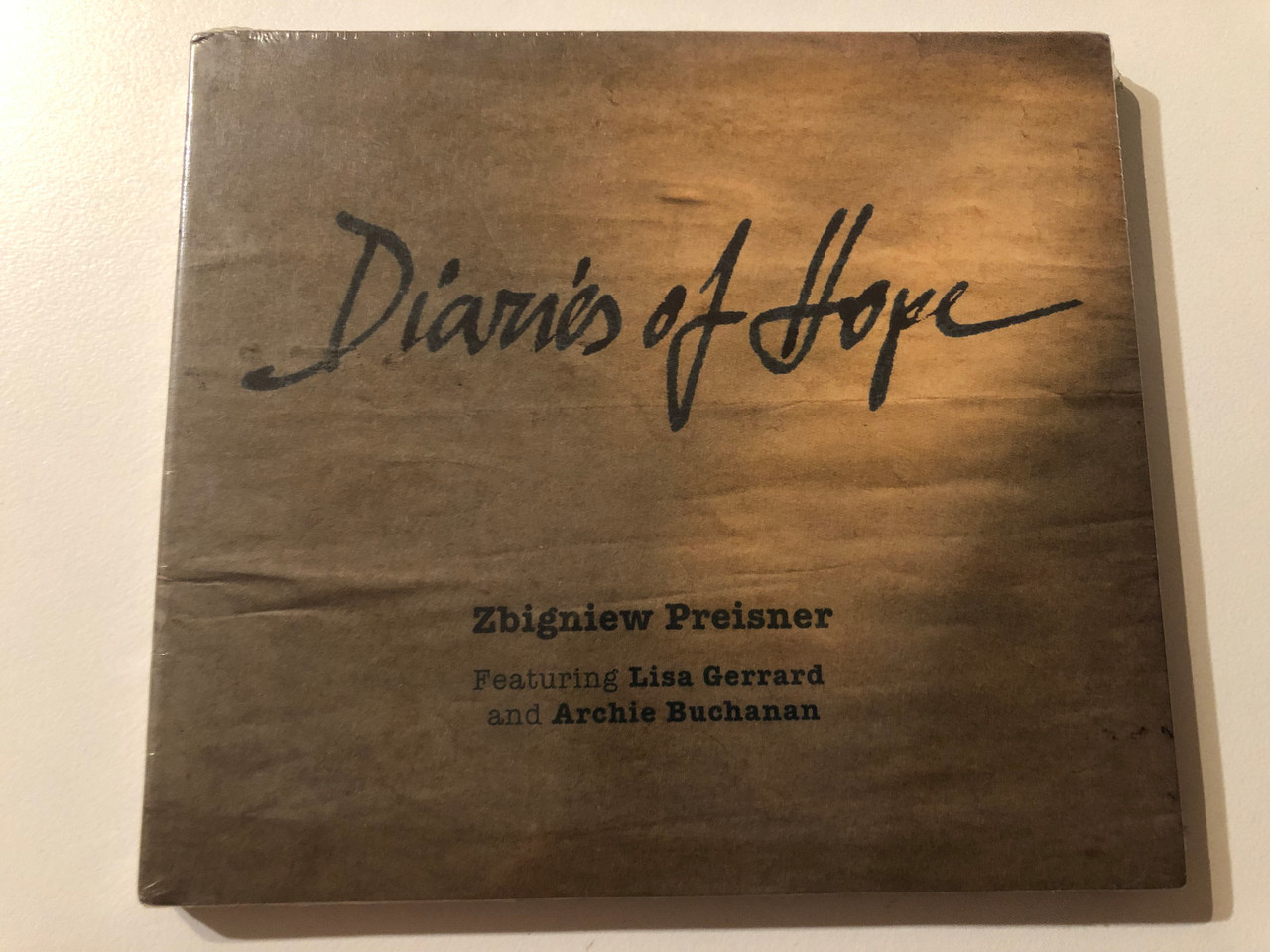 https://cdn10.bigcommerce.com/s-62bdpkt7pb/products/0/images/275791/Diaries_Of_Hope_-_Zbigniew_Preisner_Featuring_Lisa_Gerrard_And_Archie_Buchanan_Preisner_Productions_Audio_CD_2013_PPCD001_1__34214.1685600520.1280.1280.JPG?c=2&_gl=1*1xsle7k*_ga*MjA2NTIxMjE2MC4xNTkwNTEyNTMy*_ga_WS2VZYPC6G*MTY4NTU5ODY4Ni45MjEuMS4xNjg1NjAwMzI5LjQyLjAuMA..