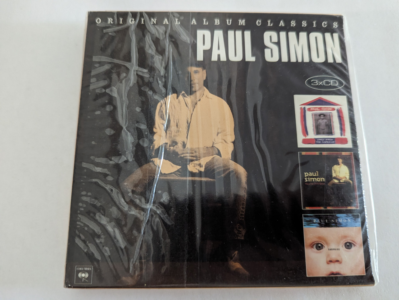 https://cdn10.bigcommerce.com/s-62bdpkt7pb/products/0/images/279657/Paul_Simon_Original_Album_Classics_Sony_Music_3x_Audio_CD_Box_Set_2012_88725474632_1__14828.1687930376.1280.1280.jpg?c=2&_gl=1*or8ytp*_ga*MjA2NTIxMjE2MC4xNTkwNTEyNTMy*_ga_WS2VZYPC6G*MTY4NzkzMDI4OC45NjcuMC4xNjg3OTMwMjg4LjYwLjAuMA..