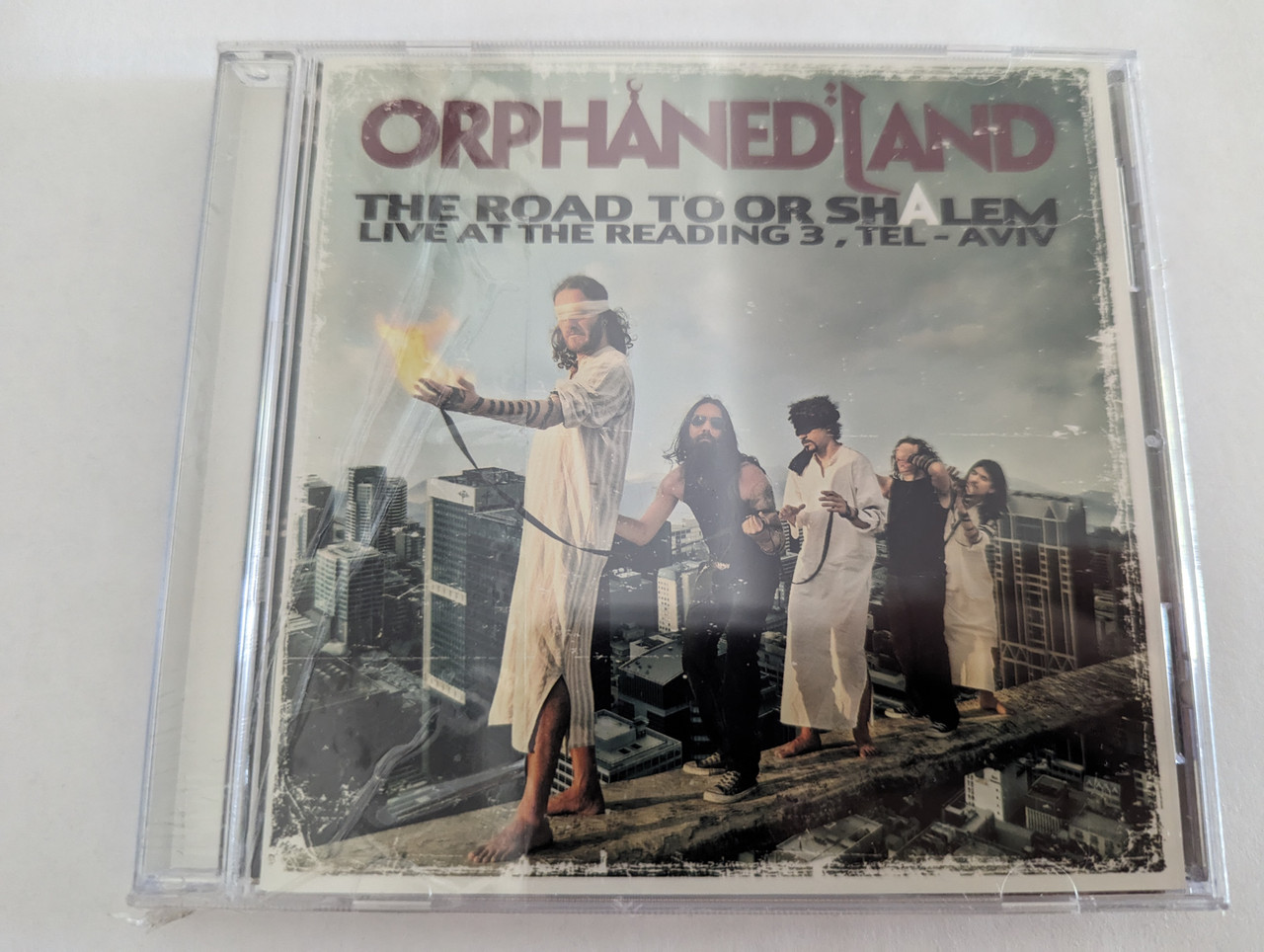 https://cdn10.bigcommerce.com/s-62bdpkt7pb/products/0/images/279672/Orphaned_Land_The_Road_To_Or_Shalem_Live_At_The_Reading_3_Tel-Aviv_Century_Media_Audio_CD_2011_9981332_1__48806.1687932338.1280.1280.jpg?c=2&_gl=1*1121gn4*_ga*MjA2NTIxMjE2MC4xNTkwNTEyNTMy*_ga_WS2VZYPC6G*MTY4NzkzMDI4OC45NjcuMS4xNjg3OTMyMjI4LjQwLjAuMA..