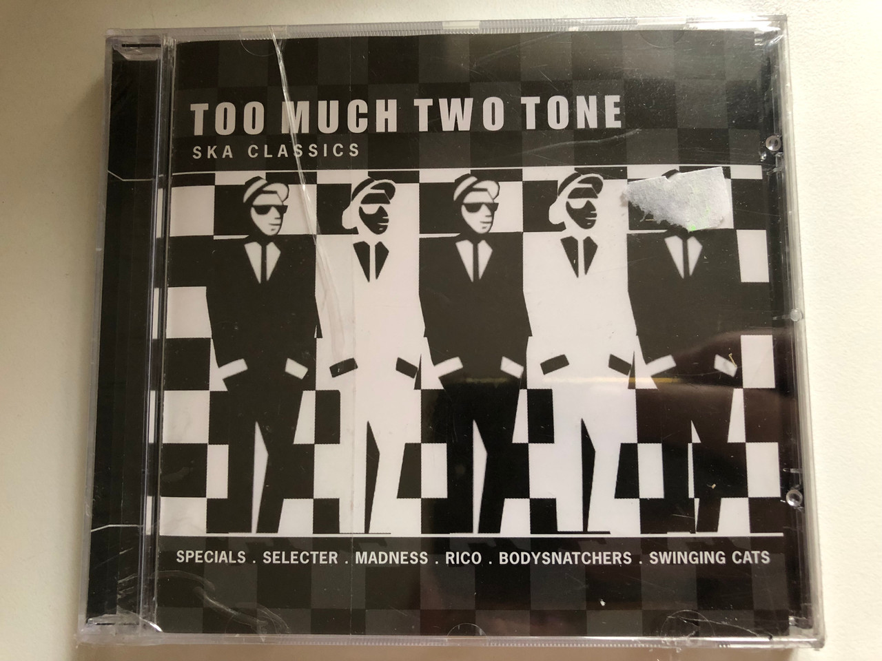 https://cdn10.bigcommerce.com/s-62bdpkt7pb/products/0/images/283756/Too_Much_Two_Tone_-_Ska_Classics_-_Specials_Selecter_Madness_Rico_Bodysnatchers_Swinging_Cats_EMI_Gold_Audio_CD_2000_724352377220_1__72120.1689335317.1280.1280.JPG?c=2&_gl=1*4bzo72*_ga*MjA2NTIxMjE2MC4xNTkwNTEyNTMy*_ga_WS2VZYPC6G*MTY4OTMzMzUzMi45ODYuMS4xNjg5MzM0ODQwLjQwLjAuMA..