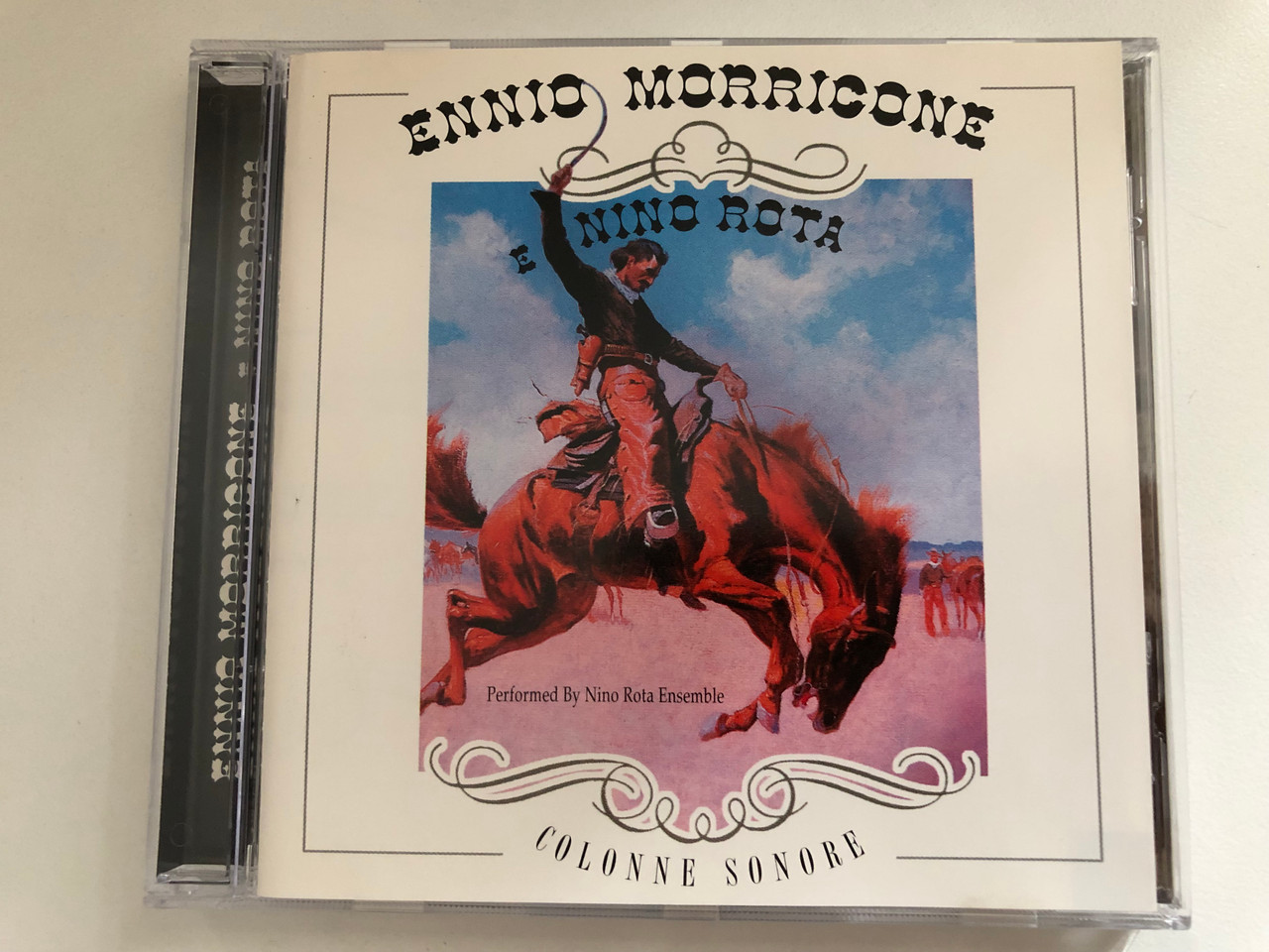 https://cdn10.bigcommerce.com/s-62bdpkt7pb/products/0/images/287254/Ennio_Morricone_E_Nino_Rota_-_Performed_by_Nino_Rota_Ensemble_Colonne_Sonore_Azzurra_Music_Audio_CD_2000_TBP1532_1__59273.1690195873.1280.1280.JPG?c=2&_gl=1*lcvmmu*_ga*MjA2NTIxMjE2MC4xNTkwNTEyNTMy*_ga_WS2VZYPC6G*MTY5MDE3ODQ1Ni45OTMuMS4xNjkwMTkzNDg1LjYwLjAuMA..