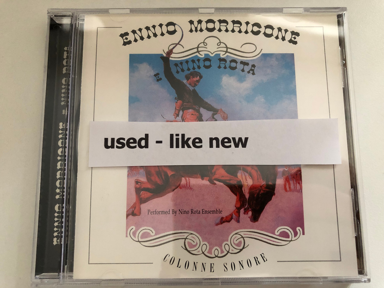 https://cdn10.bigcommerce.com/s-62bdpkt7pb/products/0/images/287259/Ennio_Morricone_E_Nino_Rota_-_Performed_by_Nino_Rota_Ensemble_Colonne_Sonore_Azzurra_Music_Audio_CD_2000_TBP1532_6__80343.1690195909.1280.1280.JPG?c=2&_gl=1*lcvmmu*_ga*MjA2NTIxMjE2MC4xNTkwNTEyNTMy*_ga_WS2VZYPC6G*MTY5MDE3ODQ1Ni45OTMuMS4xNjkwMTkzNDg1LjYwLjAuMA..