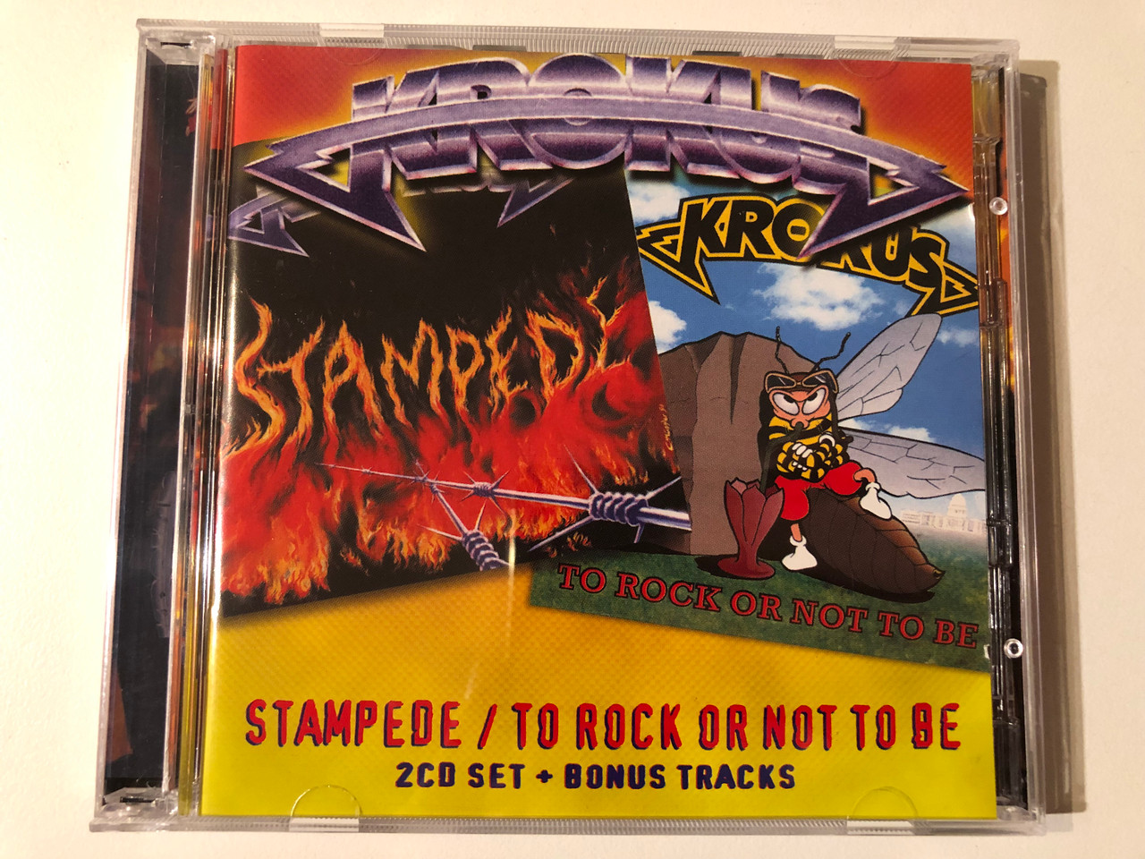 https://cdn10.bigcommerce.com/s-62bdpkt7pb/products/0/images/293185/Krokus_Stampede_To_Rock_Or_Not_To_Be_Angel_Air_Records_2x_Audio_CD_SJPCD042_1__51183.1692075412.1280.1280.JPG?c=2&_gl=1*1bkrg25*_ga*MjA2NTIxMjE2MC4xNTkwNTEyNTMy*_ga_WS2VZYPC6G*MTY5MjA3Mzc1NC4xMDIyLjEuMTY5MjA3NTE5OS40Ny4wLjA.