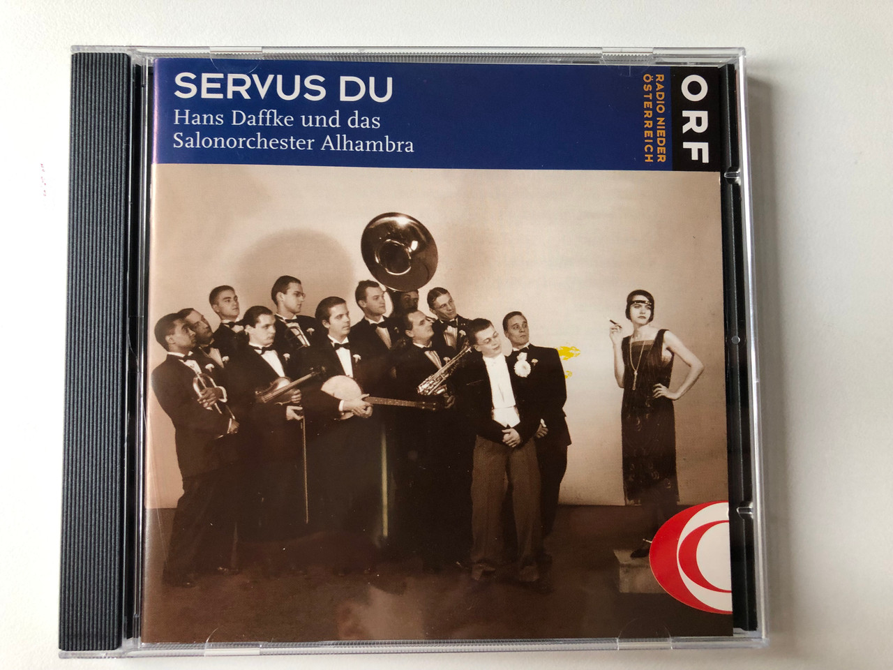 https://cdn10.bigcommerce.com/s-62bdpkt7pb/products/0/images/296688/Servus_Du_-_Hans_Daffke_Und_Das_Salonorchester_Alhambra_ORF_Radio_Niedersterreich_Audio_CD_1996_CD_103_1__79673.1693239488.1280.1280.JPG?c=2&_gl=1*4dg15s*_ga*MjA2NTIxMjE2MC4xNTkwNTEyNTMy*_ga_WS2VZYPC6G*MTY5MzIyNzczNi4xMDQ4LjEuMTY5MzIzOTMzNy40NS4wLjA.