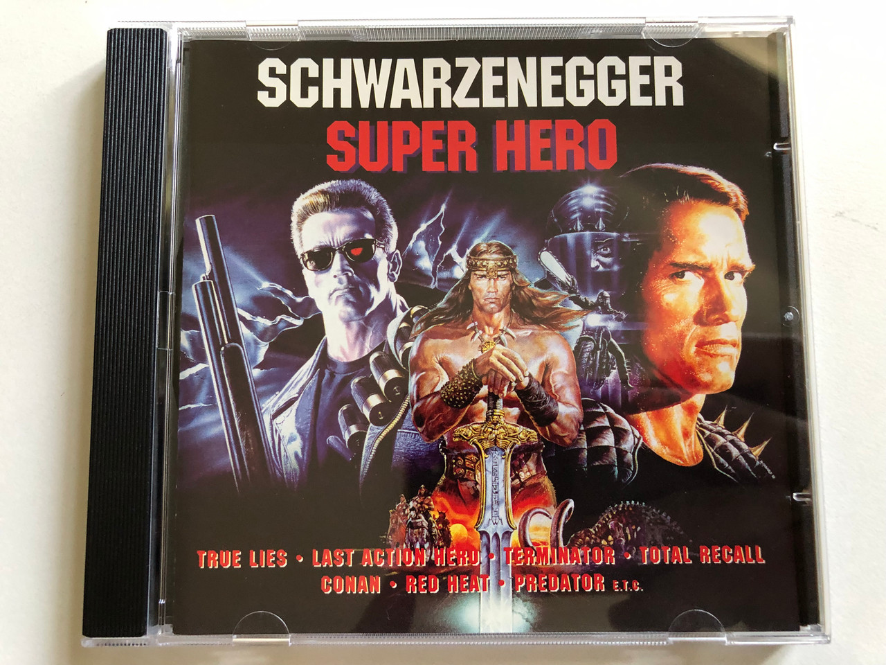 https://cdn10.bigcommerce.com/s-62bdpkt7pb/products/0/images/298042/Schwarzenegger_Super_Hero_-_True_Lies_Last_Action_Hero_Terminator_Total_Recall_Conan_Raw_Heat_Predator_etc_Cinerama_Audio_CD_1994_0022232_CIN_1__95971.1693584455.1280.1280.JPG?c=2&_gl=1*gpxx0k*_ga*MjA2NTIxMjE2MC4xNTkwNTEyNTMy*_ga_WS2VZYPC6G*MTY5MzU3NDQzOC4xMDU1LjEuMTY5MzU4NDMyNS40Mi4wLjA.
