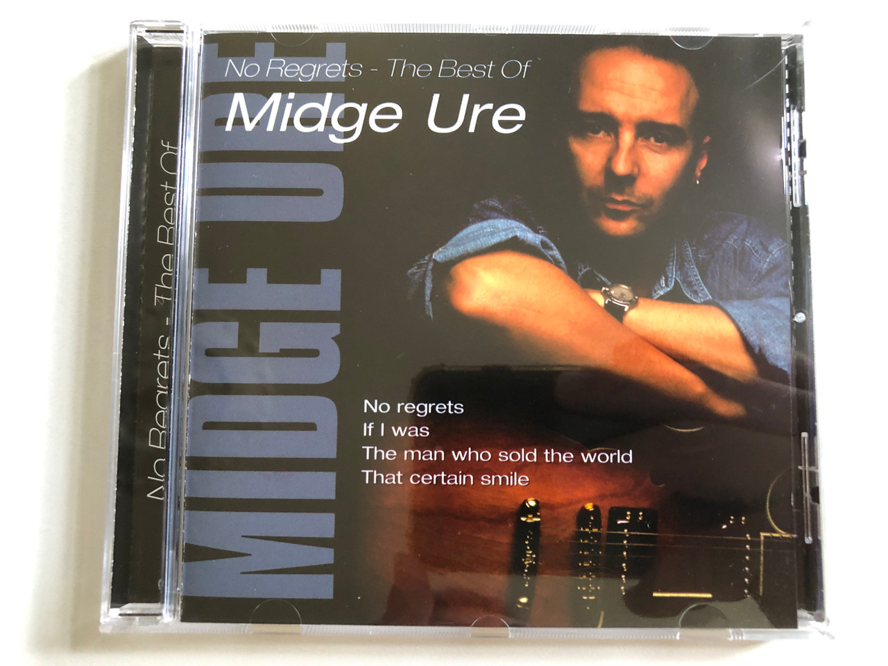 https://cdn10.bigcommerce.com/s-62bdpkt7pb/products/0/images/298749/No_Regrets_-_The_Best_Of_Midge_Ure_No_Regrets_If_I_Was_The_Man_Who_Sold_The_World_That_Certain_Smile_Disky_Audio_CD_2000_SI_997912_1__22219.1693905001.1280.1280.JPG?c=2&_gl=1*1bui2iv*_ga*MjA2NTIxMjE2MC4xNTkwNTEyNTMy*_ga_WS2VZYPC6G*MTY5Mzg5NzkwOS4xMDU5LjEuMTY5MzkwNDk3OS42MC4wLjA.