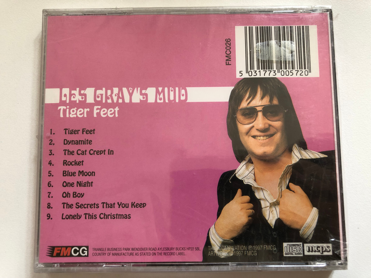https://cdn10.bigcommerce.com/s-62bdpkt7pb/products/0/images/300309/Les_Grays_Mud_-_Tiger_Feet_Including_Dynamite_Rocket_Lonely_This_Christmas_FMCG_Audio_CD_1997_FMC026_2__98602.1694449571.1280.1280.JPG?c=2&_gl=1*j3r7qb*_ga*MjA2NTIxMjE2MC4xNTkwNTEyNTMy*_ga_WS2VZYPC6G*MTY5NDQ0ODU0Ny4xMDY1LjEuMTY5NDQ0OTU1Ny42MC4wLjA.