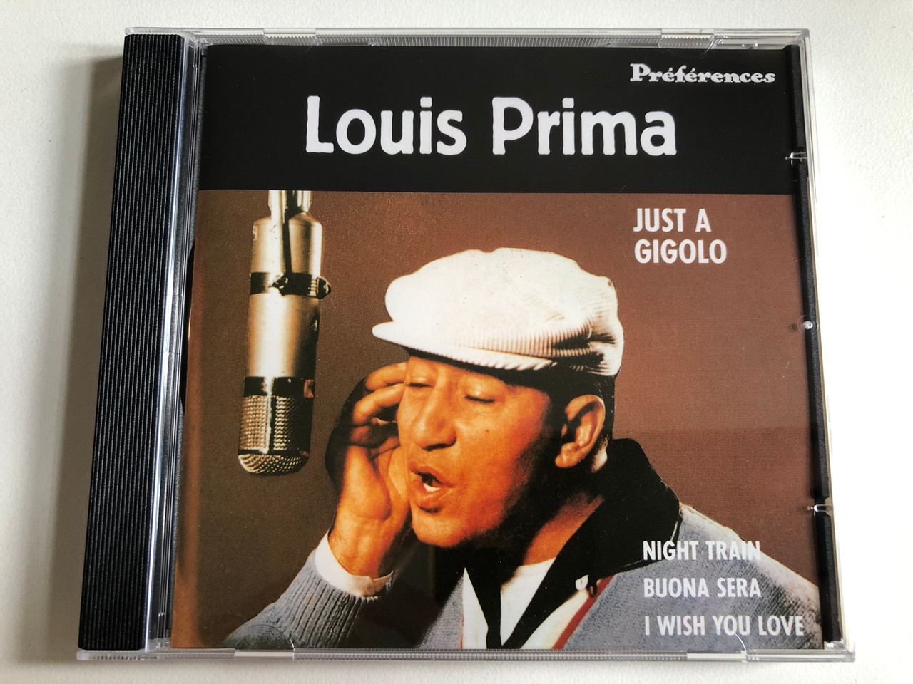 https://cdn10.bigcommerce.com/s-62bdpkt7pb/products/0/images/301011/Louis_Prima_Just_A_Gigolo_-_Night_Train_Buona_Sera_I_Wish_You_Love_Prfrences_Audio_CD_1991_Mono_Stereo_252_607-2_1__85173.1694593392.1280.1280.JPG?c=2&_gl=1*1ddiyg2*_ga*MjA2NTIxMjE2MC4xNTkwNTEyNTMy*_ga_WS2VZYPC6G*MTY5NDU4MjcxNC4xMDY4LjEuMTY5NDU5MzE0NC41MC4wLjA.