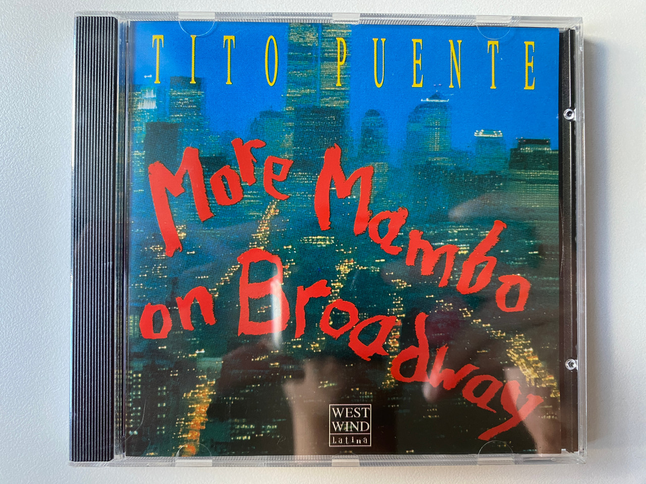 https://cdn10.bigcommerce.com/s-62bdpkt7pb/products/0/images/302081/Tito_Puente_More_Mambo_On_Broadway_West_Wind_Latina_Audio_CD_1991_ww_2203_1__94024.1695974742.1280.1280.jpg?c=2&_gl=1*1juqbqb*_ga*MjA2NTIxMjE2MC4xNTkwNTEyNTMy*_ga_WS2VZYPC6G*MTY5NTk2Nzc2My4xMDc2LjEuMTY5NTk3NDYwOS4xNC4wLjA.