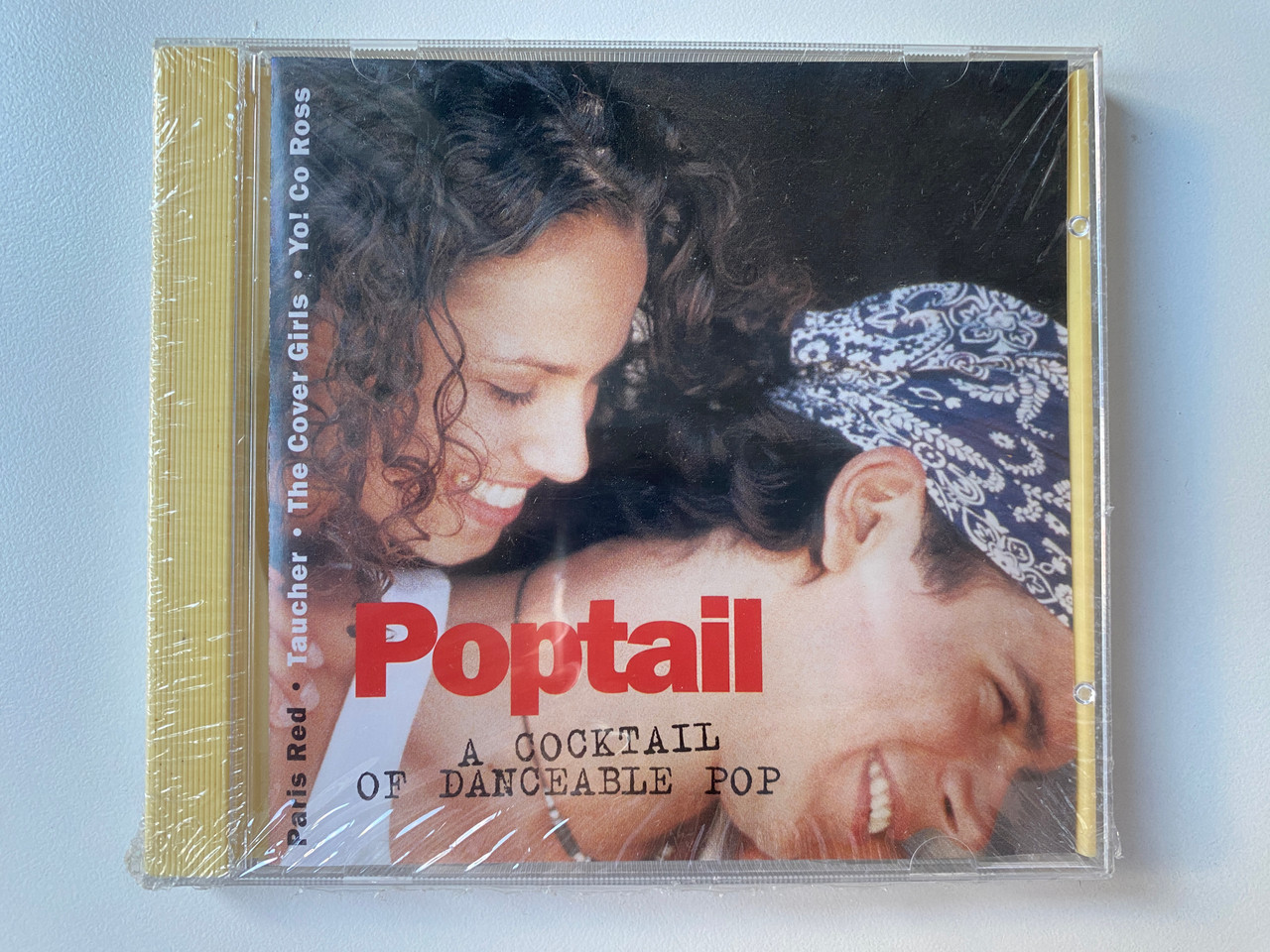 https://cdn10.bigcommerce.com/s-62bdpkt7pb/products/0/images/302125/Poptail_A_Cocktail_Of_Danceable_Pop_-_Paris_Red_Taucher_The_Cover_Girls_Yo_Co_Ross_Sony_Music_Media_Audio_CD_1996_485039_2_1__72631.1696225896.1280.1280.jpg?c=2&_gl=1*jzmk4h*_ga*MjA2NTIxMjE2MC4xNTkwNTEyNTMy*_ga_WS2VZYPC6G*MTY5NjIyNDYyMS4xMDc5LjEuMTY5NjIyNTc0Ni40MS4wLjA.