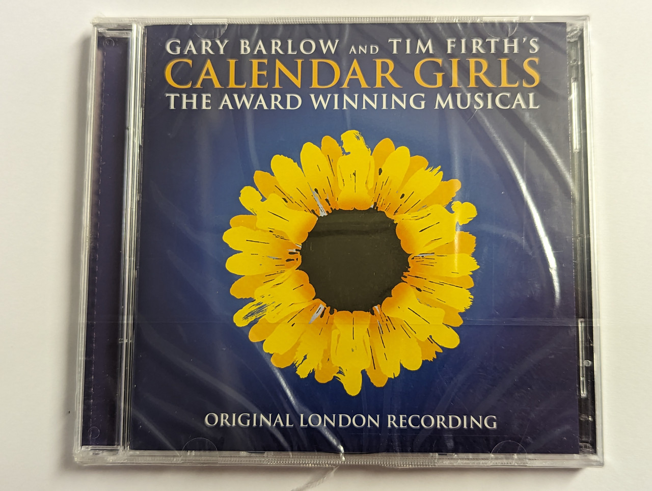 https://cdn10.bigcommerce.com/s-62bdpkt7pb/products/0/images/302308/Gary_Barlow_And_Tim_Firth_-_Calendar_Girls_The_Award_Winning_Musical_Original_London_Recording_Original_London_Recording_Decca_2x_Audio_CD_2018_6738165_1__66083.1696330591.1280.1280.jpg?c=2&_gl=1*1ggjale*_ga*MjA2NTIxMjE2MC4xNTkwNTEyNTMy*_ga_WS2VZYPC6G*MTY5NjMyNjUxMy4xMDgzLjEuMTY5NjMzMDQ2Ny41Mi4wLjA.