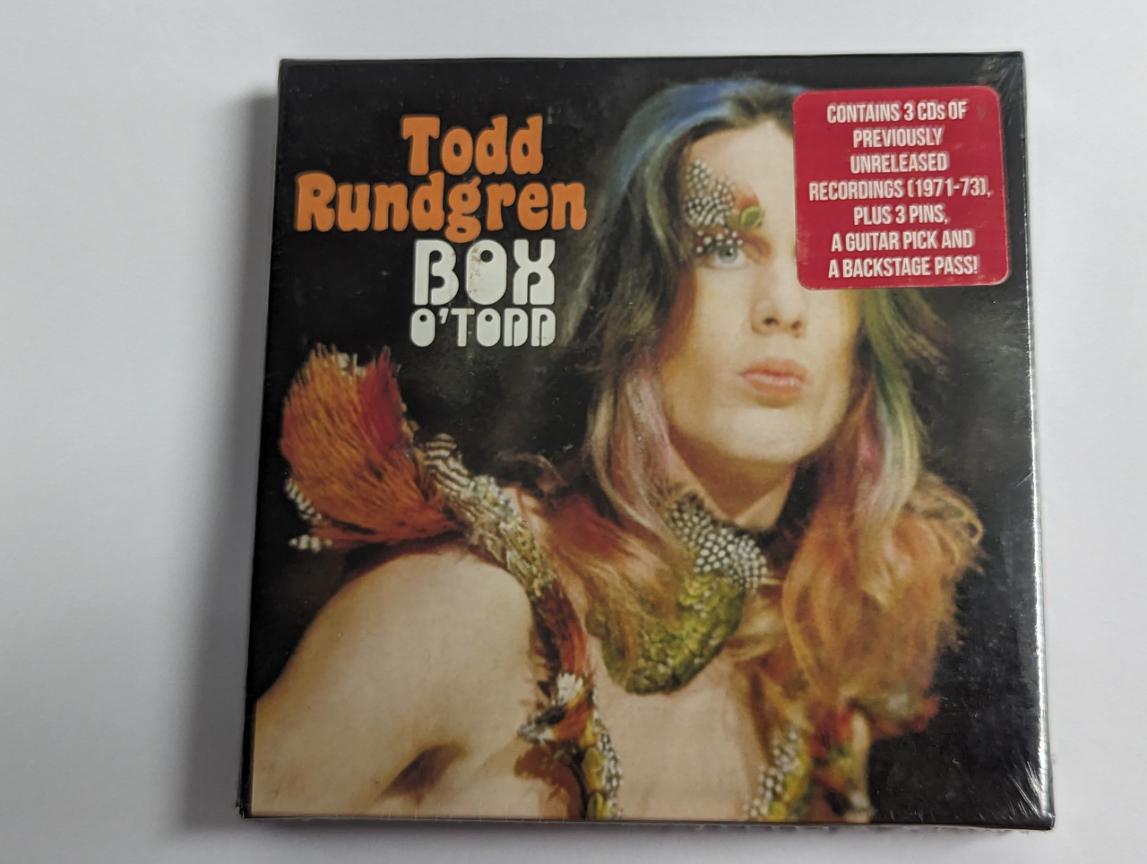 https://cdn10.bigcommerce.com/s-62bdpkt7pb/products/0/images/302461/Todd_Rundgren_Box_O_Todd_Contains_3CDs_Of_Previously_Unreleased_Recordings_1971-73_Plus_3_Pins_A_Guitar_Pick_And_A_Backstage_Pass_Purple_Pyramid_3x_Audio_CD_Box_Set_2016_88946601_1__71289.1696410942.1280.1280.jpg?c=2&_gl=1*1xwvgbs*_ga*MjA2NTIxMjE2MC4xNTkwNTEyNTMy*_ga_WS2VZYPC6G*MTY5NjQwNzEwMS4xMDg1LjEuMTY5NjQxMTA0NC42MC4wLjA.