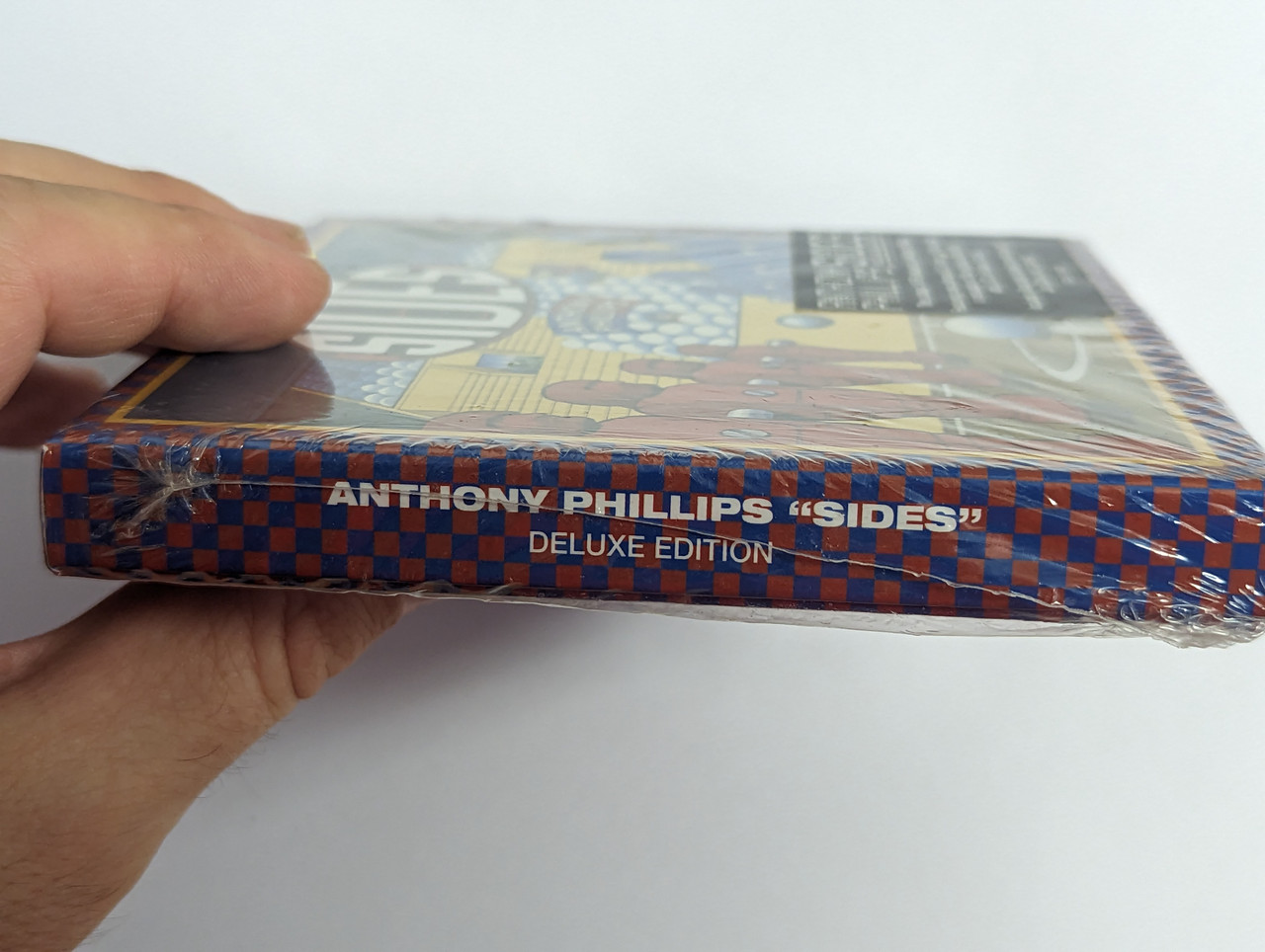 https://cdn10.bigcommerce.com/s-62bdpkt7pb/products/0/images/302578/Anthony_Phillips_Sides_4_Disc_Deluxe_Edition_The_classic_1979_album_by_Anthony_Philips_Featuring_new_stereo_5._1_mixes_of_the_album_a_remaster_of_the_original_stereo_mix_Esoteric_3__79473.1696510874.1280.1280.jpg?c=2&_gl=1*1201att*_ga*MjA2NTIxMjE2MC4xNTkwNTEyNTMy*_ga_WS2VZYPC6G*MTY5NjUxMDI4Ny4xMDg5LjEuMTY5NjUxMDU2OC41MS4wLjA.