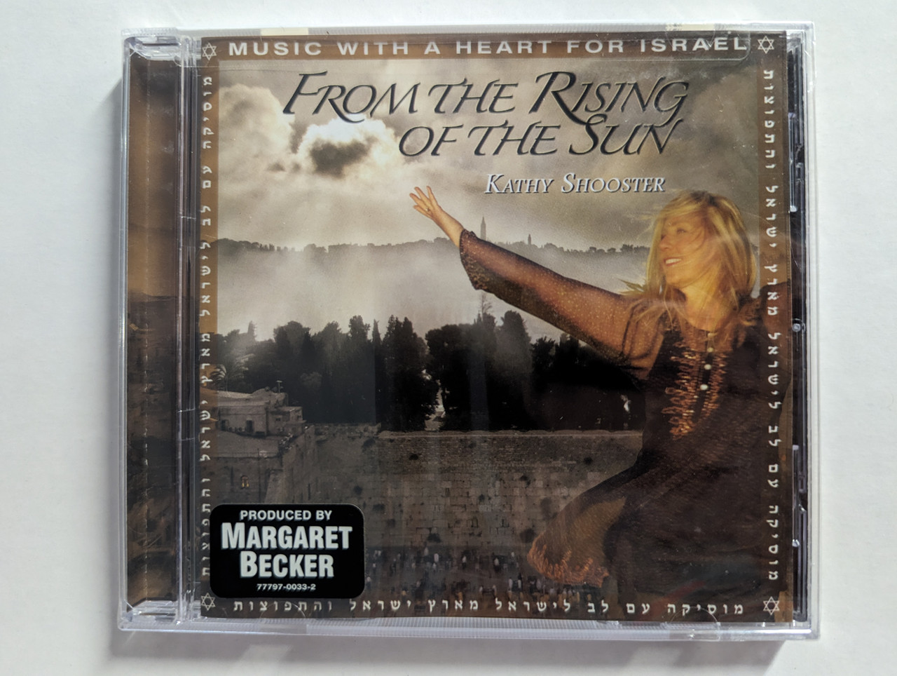 https://cdn10.bigcommerce.com/s-62bdpkt7pb/products/0/images/302602/Kathy_Shooster_From_The_Rising_Of_The_Sun_-_Produced_By_Margaret_Becker_Galilee_Of_The_Nations_Audio_CD_777970033-2_1__21042.1696566571.1280.1280.jpg?c=2&_gl=1*3bdugf*_ga*MjA2NTIxMjE2MC4xNTkwNTEyNTMy*_ga_WS2VZYPC6G*MTY5NjU2NTA1My4xMDkwLjEuMTY5NjU2NjMwOS42MC4wLjA.