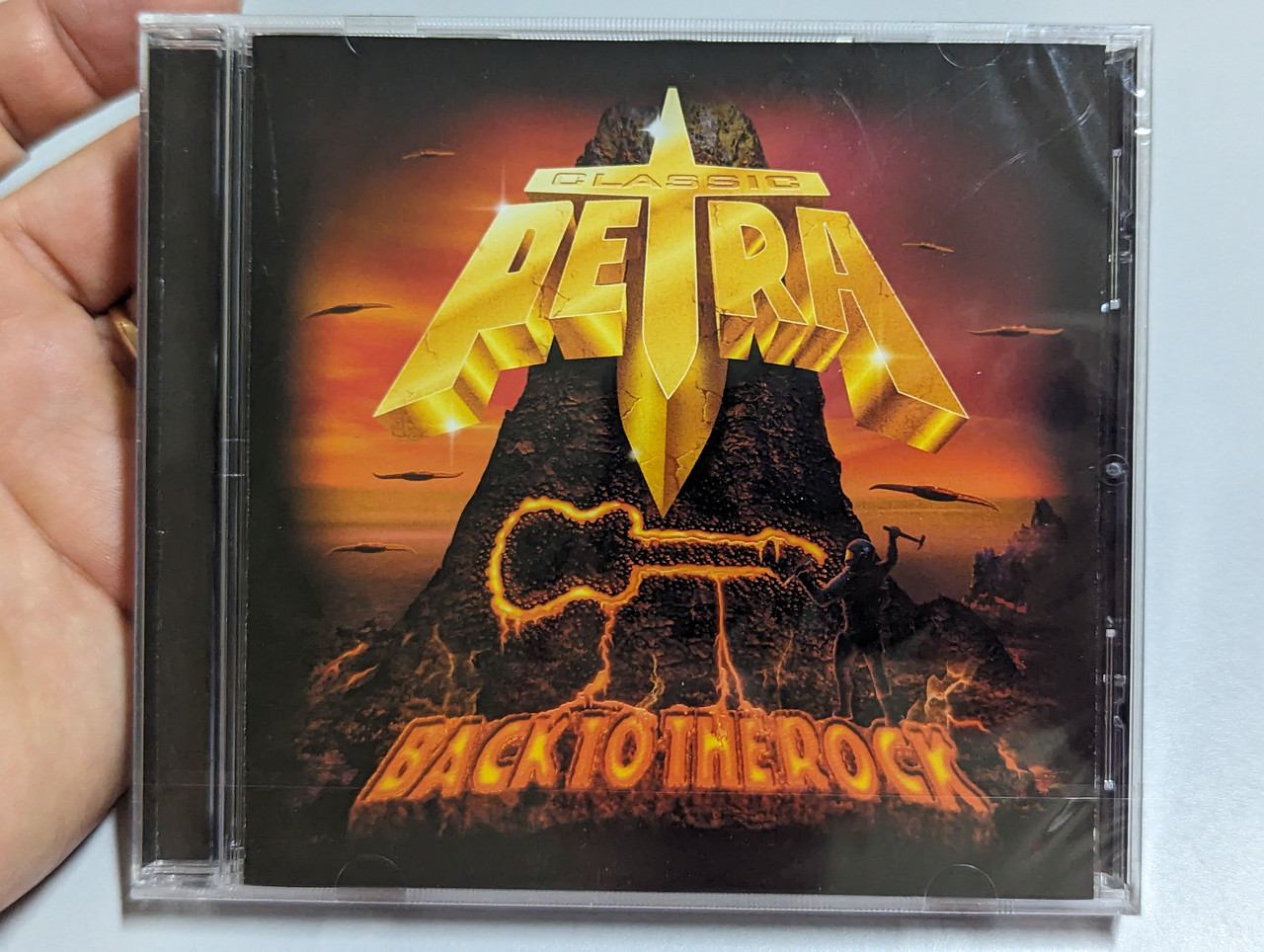https://cdn10.bigcommerce.com/s-62bdpkt7pb/products/0/images/303402/Classic_Petra_Back_To_The_Rock_Audio_CD_2010_1__51771.1697038655.1280.1280.jpg?c=2&_gl=1*12st4xj*_ga*MjA2NTIxMjE2MC4xNTkwNTEyNTMy*_ga_WS2VZYPC6G*MTY5NzAyOTYwNy4xMDk3LjEuMTY5NzAzODQwOC40OS4wLjA.