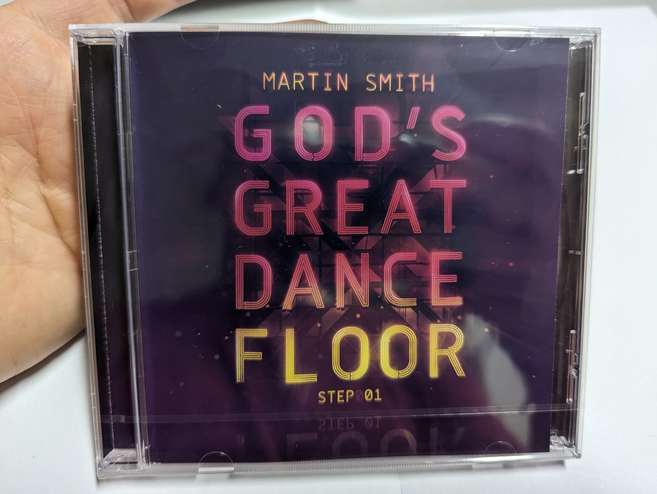 https://cdn10.bigcommerce.com/s-62bdpkt7pb/products/0/images/303424/Martin_Smith_Gods_Great_Dance_Floor_Step001_Integrity_Music_Audio_CD_2013_51902_1__89033.1697041471.1280.1280.jpg?c=2&_gl=1*kr0onu*_ga*MjA2NTIxMjE2MC4xNTkwNTEyNTMy*_ga_WS2VZYPC6G*MTY5NzAyOTYwNy4xMDk3LjEuMTY5NzA0MTMwMy41OC4wLjA.