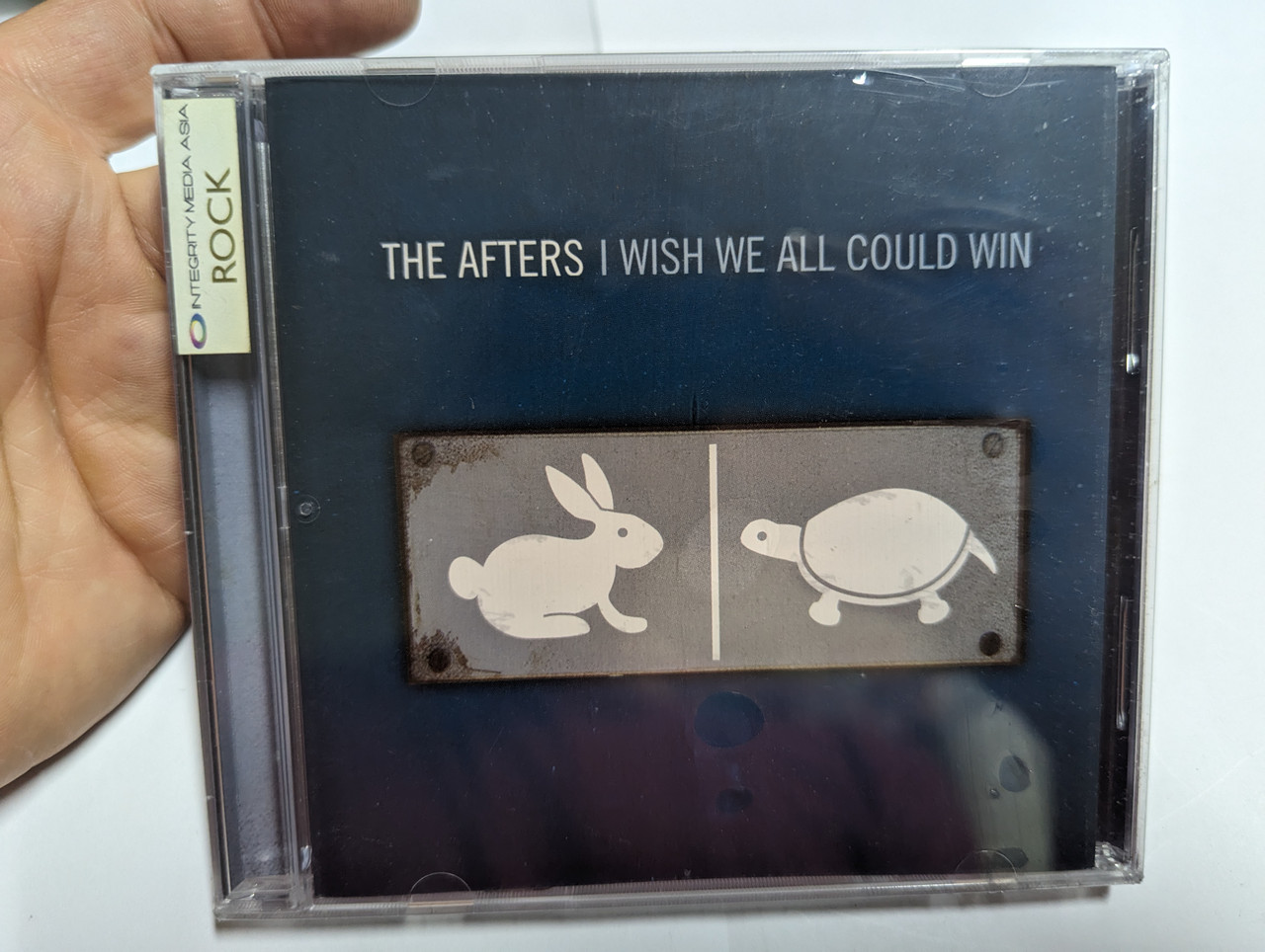 https://cdn10.bigcommerce.com/s-62bdpkt7pb/products/0/images/303432/The_Afters_I_Wish_We_All_Could_Win_Simple_Records_Audio_CD_2005_000768306925_1__40251.1697045597.1280.1280.jpg?c=2&_gl=1*1sq55bj*_ga*MjA2NTIxMjE2MC4xNTkwNTEyNTMy*_ga_WS2VZYPC6G*MTY5NzAyOTYwNy4xMDk3LjEuMTY5NzA0MTU1MS41MC4wLjA.