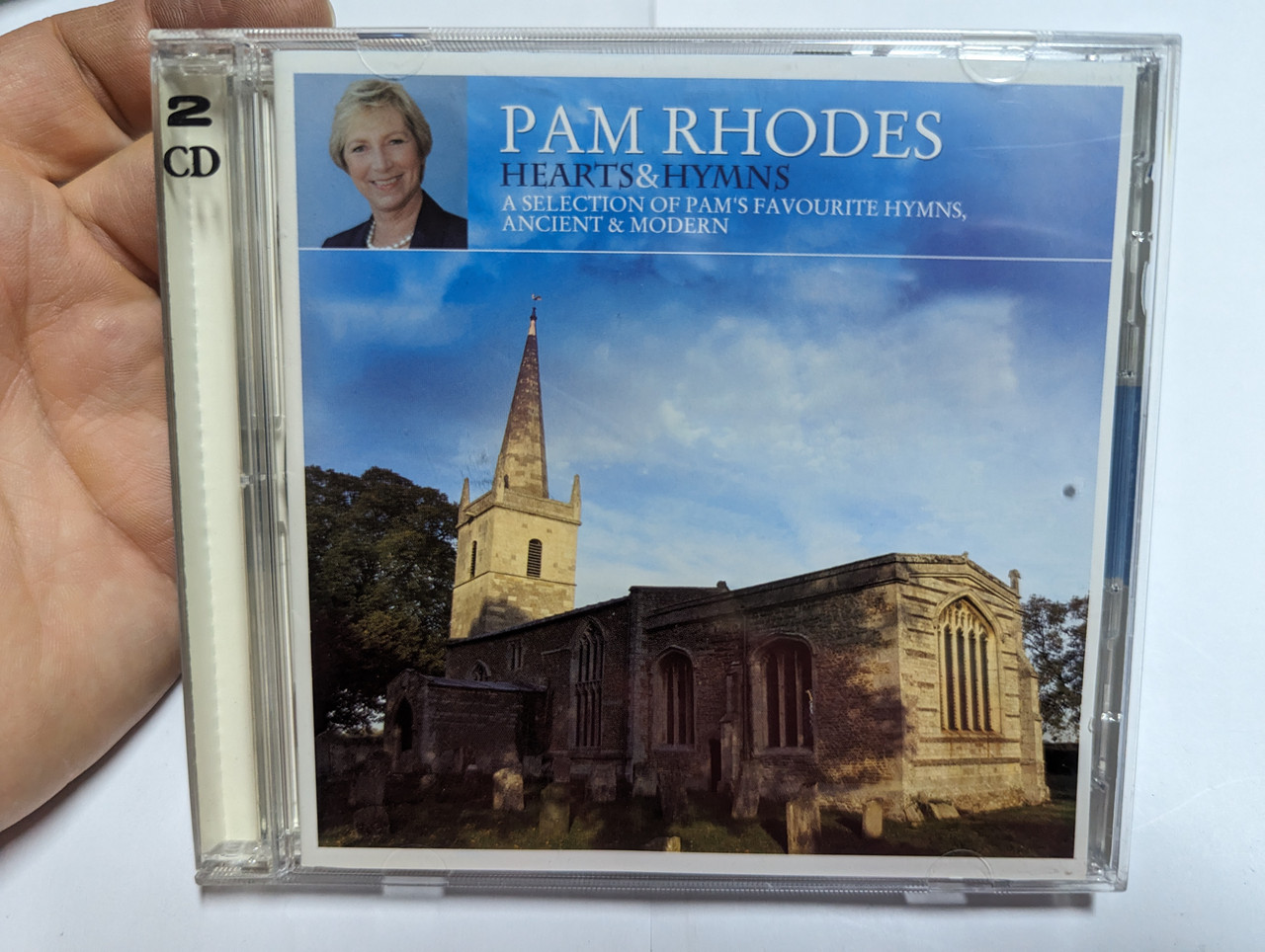 https://cdn10.bigcommerce.com/s-62bdpkt7pb/products/0/images/303453/Pam_Rhodes_Hearts_Hymns_A_Selection_Of_Pams_Favourite_Hymns_Ancient_Modern_Kingsway_2x_Audio_CD_2012_KWCD3297_1__13914.1697100495.1280.1280.jpg?c=2&_gl=1*1igwkec*_ga*MjA2NTIxMjE2MC4xNTkwNTEyNTMy*_ga_WS2VZYPC6G*MTY5NzA5OTY2MS4xMDk5LjEuMTY5NzEwMDI5OS41OS4wLjA.