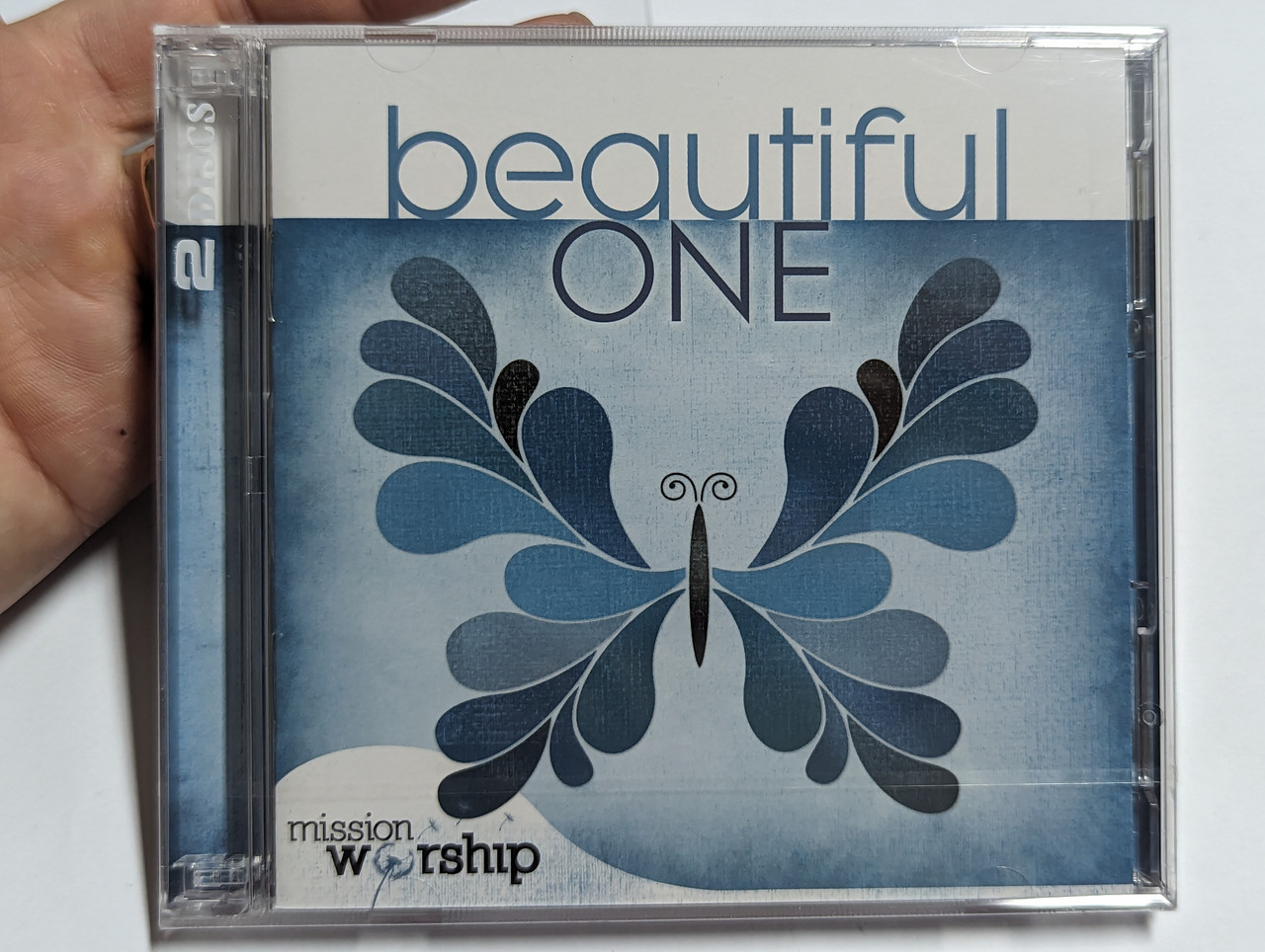 https://cdn10.bigcommerce.com/s-62bdpkt7pb/products/0/images/303888/Beautiful_One_Mission_Worship_2x_Audio_CD_2010_KMCD3114_1__45710.1697432876.1280.1280.jpg?c=2&_gl=1*lcgysy*_ga*MjA2NTIxMjE2MC4xNTkwNTEyNTMy*_ga_WS2VZYPC6G*MTY5NzQzMDkyOS4xMTA0LjEuMTY5NzQzMjczMS4zNy4wLjA.