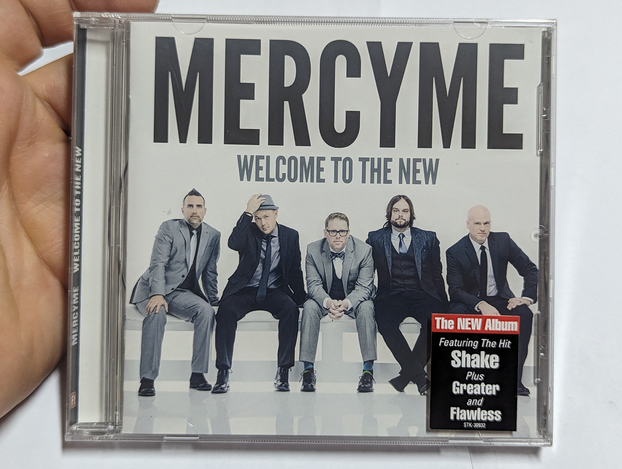 https://cdn10.bigcommerce.com/s-62bdpkt7pb/products/0/images/303897/MercyMe_Welcome_To_The_New_Featuring_The_Hit_Shake_Plus_Greater_and_Flawless_Fair_Trade_Services_Audio_CD_2014_696859309328_1__12759.1697434509.1280.1280.jpg?c=2&_gl=1*y2r791*_ga*MjA2NTIxMjE2MC4xNTkwNTEyNTMy*_ga_WS2VZYPC6G*MTY5NzQzMDkyOS4xMTA0LjEuMTY5NzQzNDQ4MC42MC4wLjA.