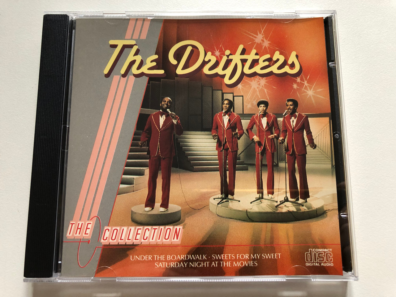 https://cdn10.bigcommerce.com/s-62bdpkt7pb/products/0/images/306634/The_Drifters_The_Collection_Under_The_Boardwalk_Sweets_For_My_Sweet_Saturday_Night_At_The_Movies_Object_Enterprises_Audio_CD_1986_R0007_1__63140.1698328893.1280.1280.JPG?c=2