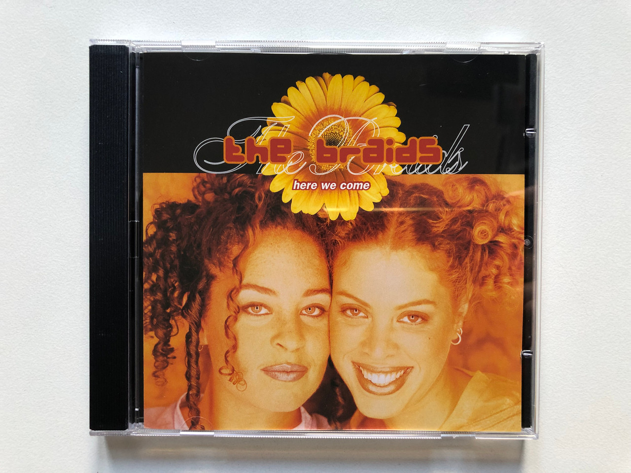 https://cdn10.bigcommerce.com/s-62bdpkt7pb/products/0/images/307506/The_Braids_Here_We_Come_Atlantic_Audio_CD_1998_7567-92749-2_1__85177.1698729934.1280.1280.JPG?c=2