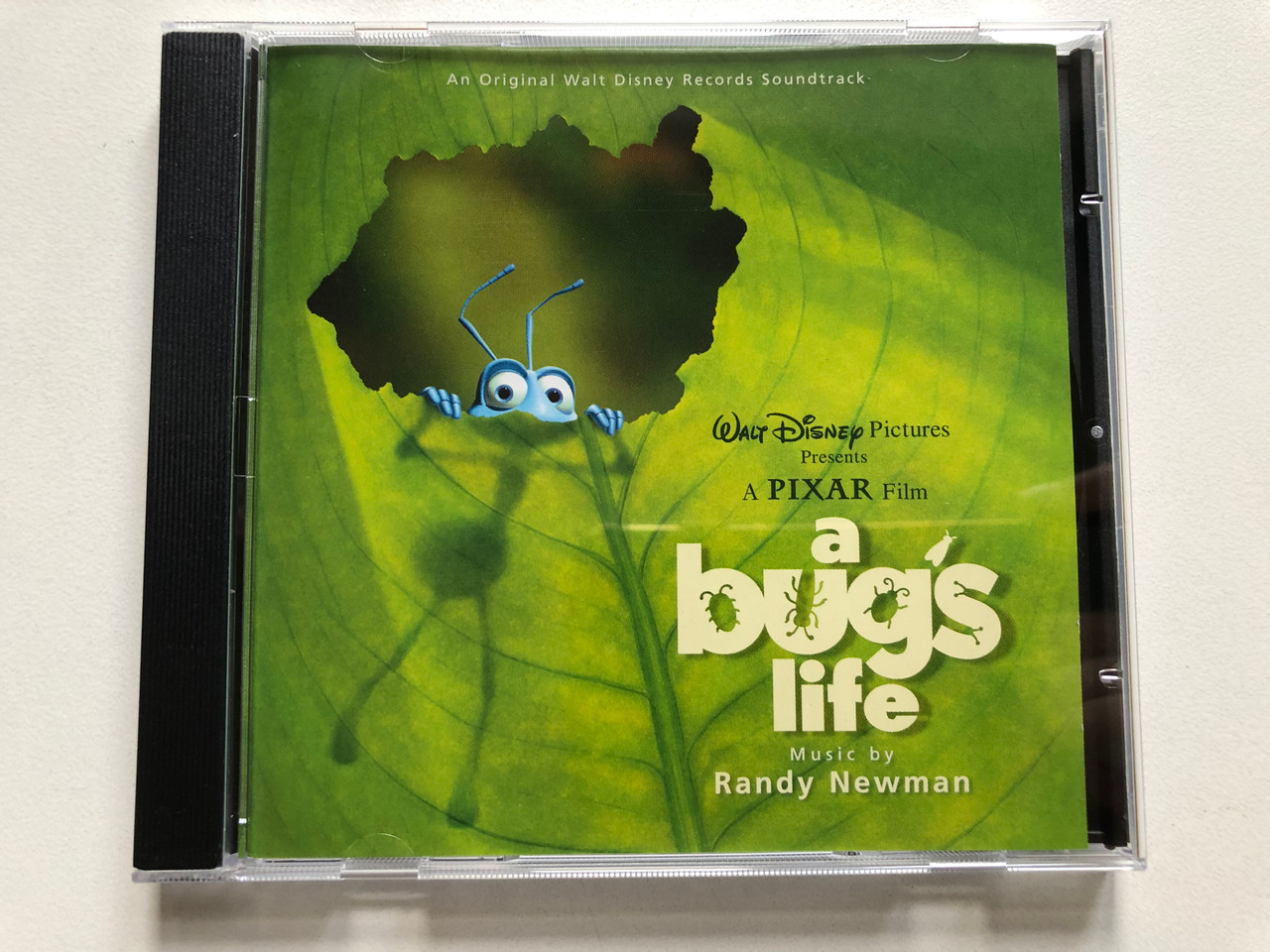 https://cdn10.bigcommerce.com/s-62bdpkt7pb/products/0/images/307699/A_Bugs_Life_-_Music_By_Randy_Newman_An_Original_Walt_Disney_Records_Soundtrack_Walt_Disney_Pictures_Presents_A_Pixar_Film_Walt_Disney_Records_Audio_CD_1998_0106342DNY_1__67153.1698818784.1280.1280.JPG?c=2